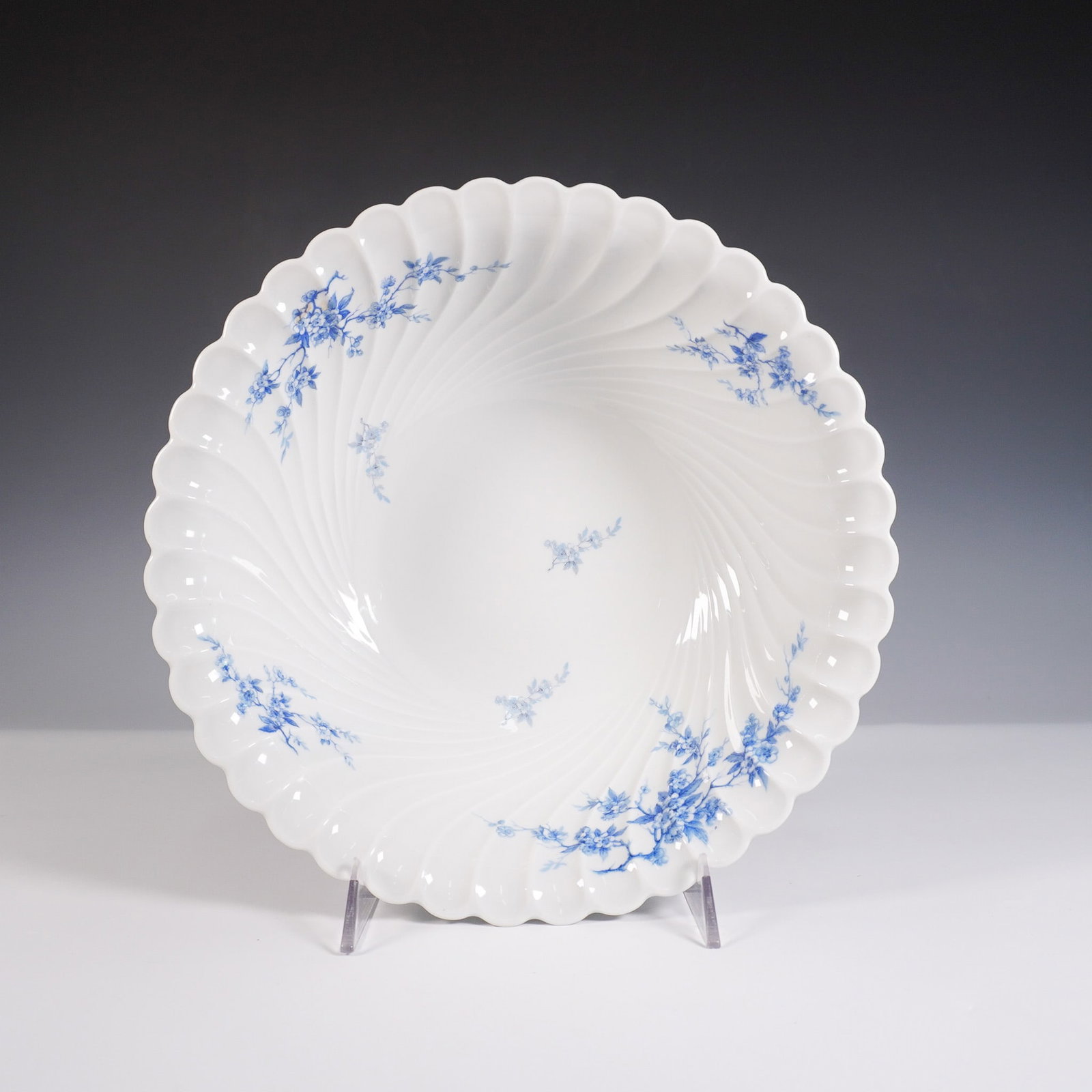 Haviland Limoges Porcelain Bowl, Blue Floral Swirl Design: Charming white porcelain bowl by Haviland Limoges, France, featuring a graceful scalloped rim and swirling relief design. Adorned with delicate blue floral sprays, this finely crafted piece showcases 