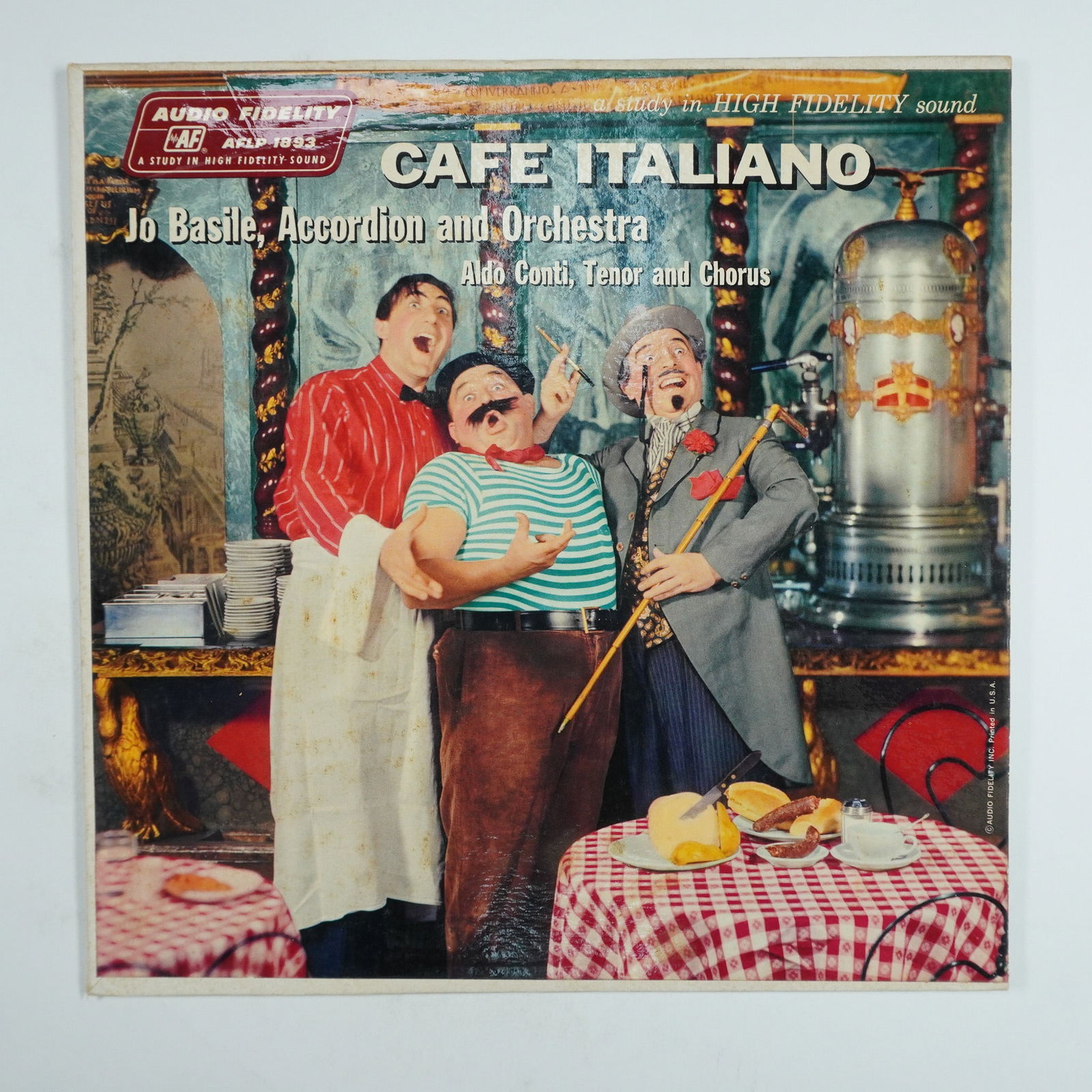 Cafe Italiano Vinyl Record, Jo Basile, Accordion and Orchestra: This vintage vinyl record features Cafe Italiano by Jo Basile, with accordion performance by Jo Basile and vocals by Aldo Conti, released under Audio Fidelity (AFLP 1893). The album includes Italian-i
