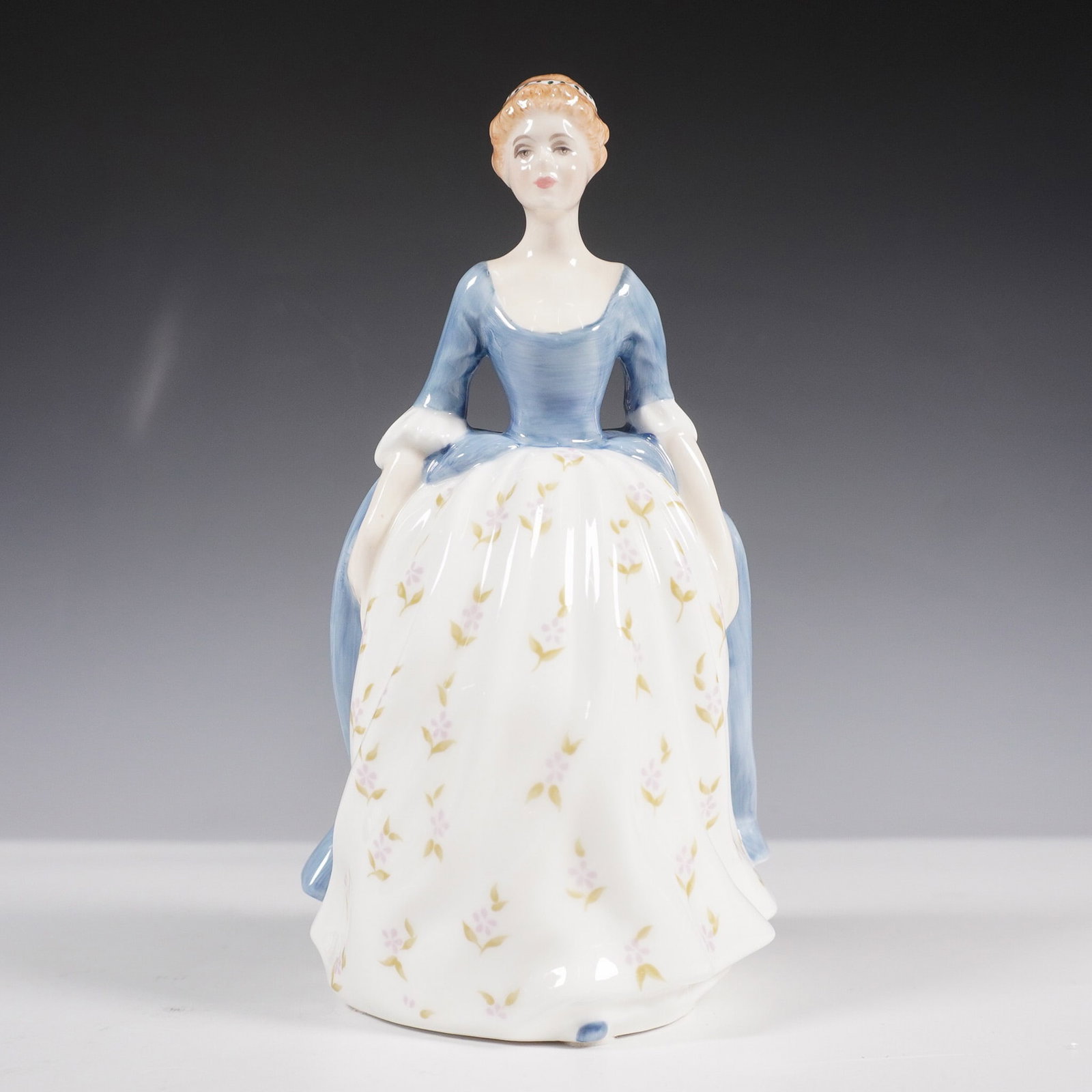 Royal Doulton Figurine, Alison HN2336: Fine bone china figurine from the Peggy Davies Classic series. The figurine was produced by Royal Doulton in 1965. Designed with a flowing gown in blue and white, adorned with delicate floral patterns