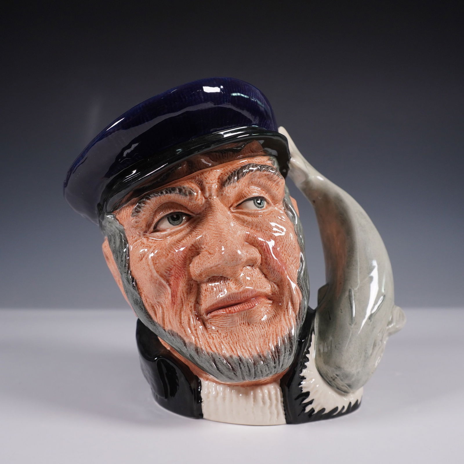 Royal Doulton Large Character Jug D6500 Capt Ahab: Large Royal Doulton character jug Capt Ahab (D6500), issued in 1958. Inspired by Melville's Moby-Dick, it features the captain in a blue cap with a whale-shaped handle. Marked with the Royal Doulton b