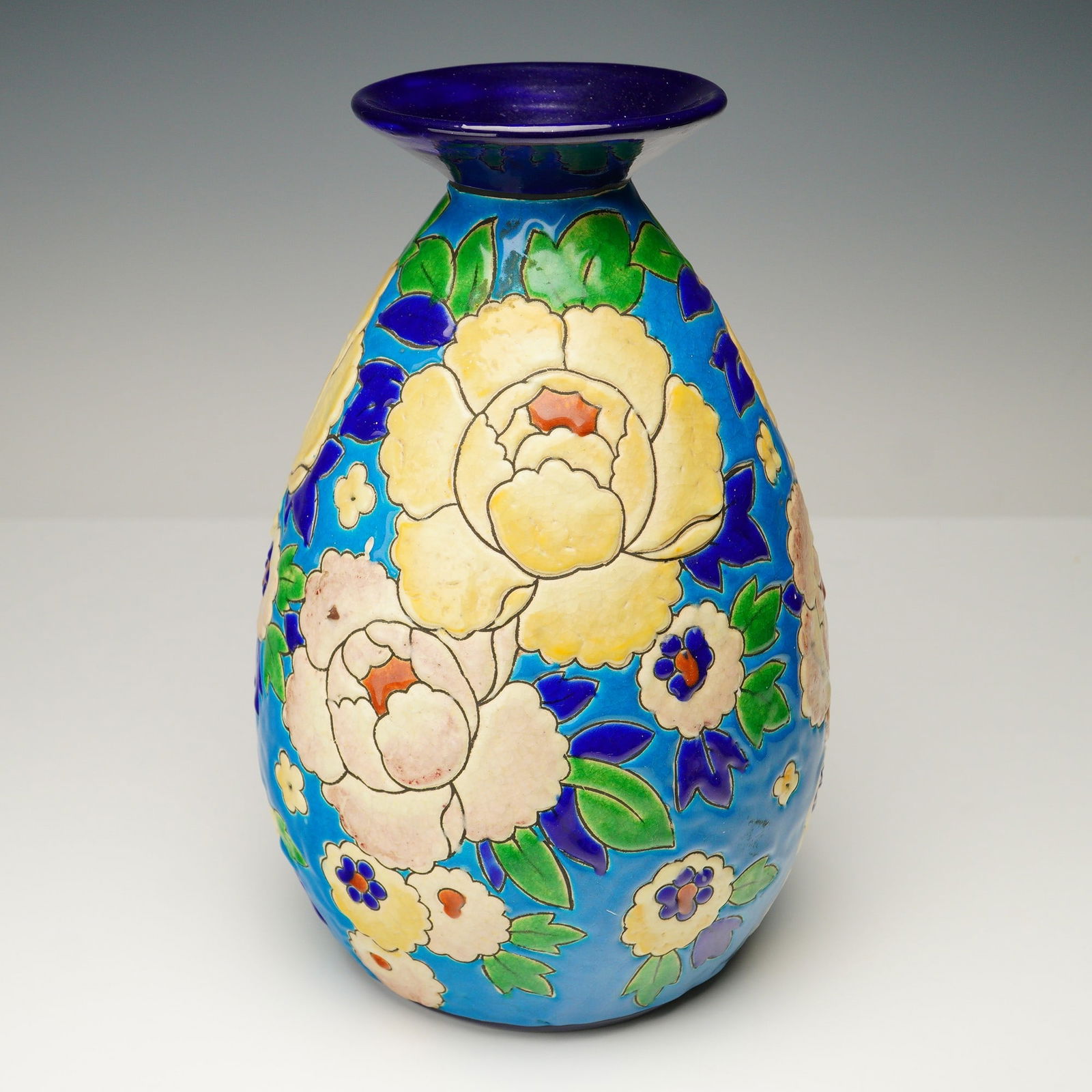 Boch Keramis by Charles Catteau Art Deco Floral Vase, D1651: This creamware vase was produced at the Boch workshop in La Louviere, Belgium. The piece was created using the slip-casting technique and decorated with printed contours, which were subsequently hand-