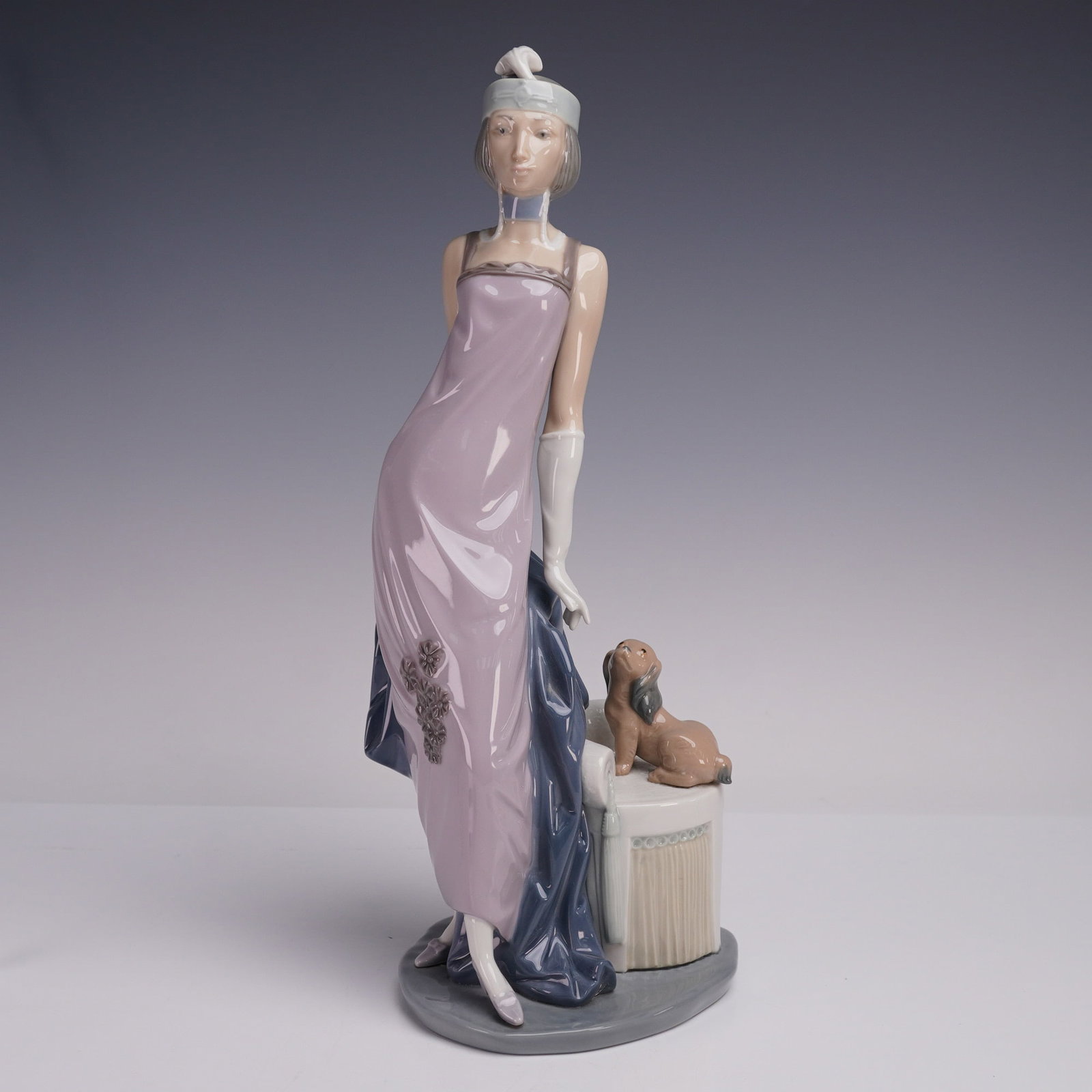 Lladro Porcelain Figurine, Couplet Lady 01005174: Lladro porcelain figurine 01005174, titled Couplet Lady, sculpted by Vincente Martinez. Also known by its Spanish name Dama Cuple, this figurine depicts an elegant lady in a lavender evening gown with