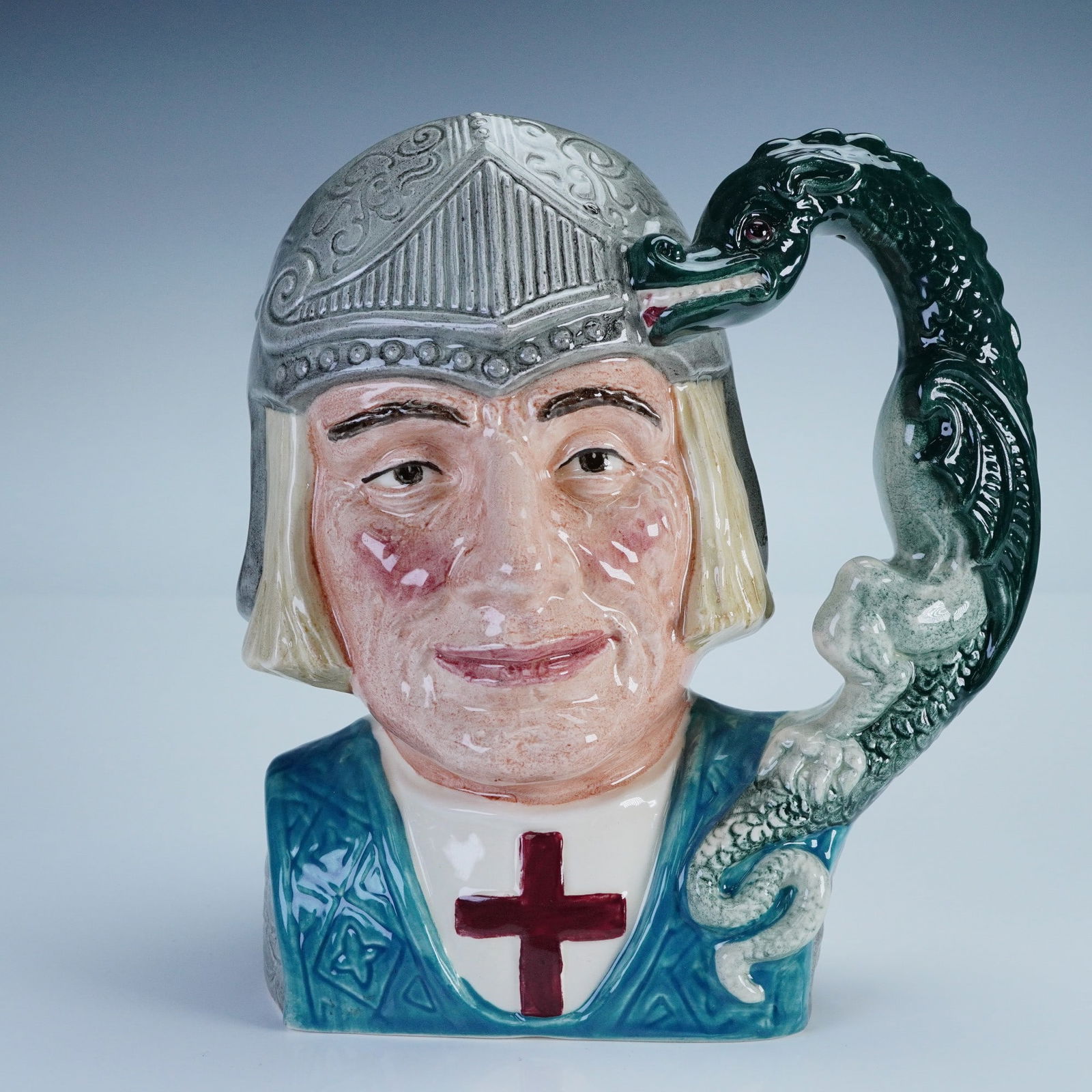 Royal Doulton Character Jug, St George D6618: Royal Doulton character jug depicting St George, the legendary dragon-slaying patron saint of England. This large jug features St George in medieval armor with a dragon forming the handle, symbolizing