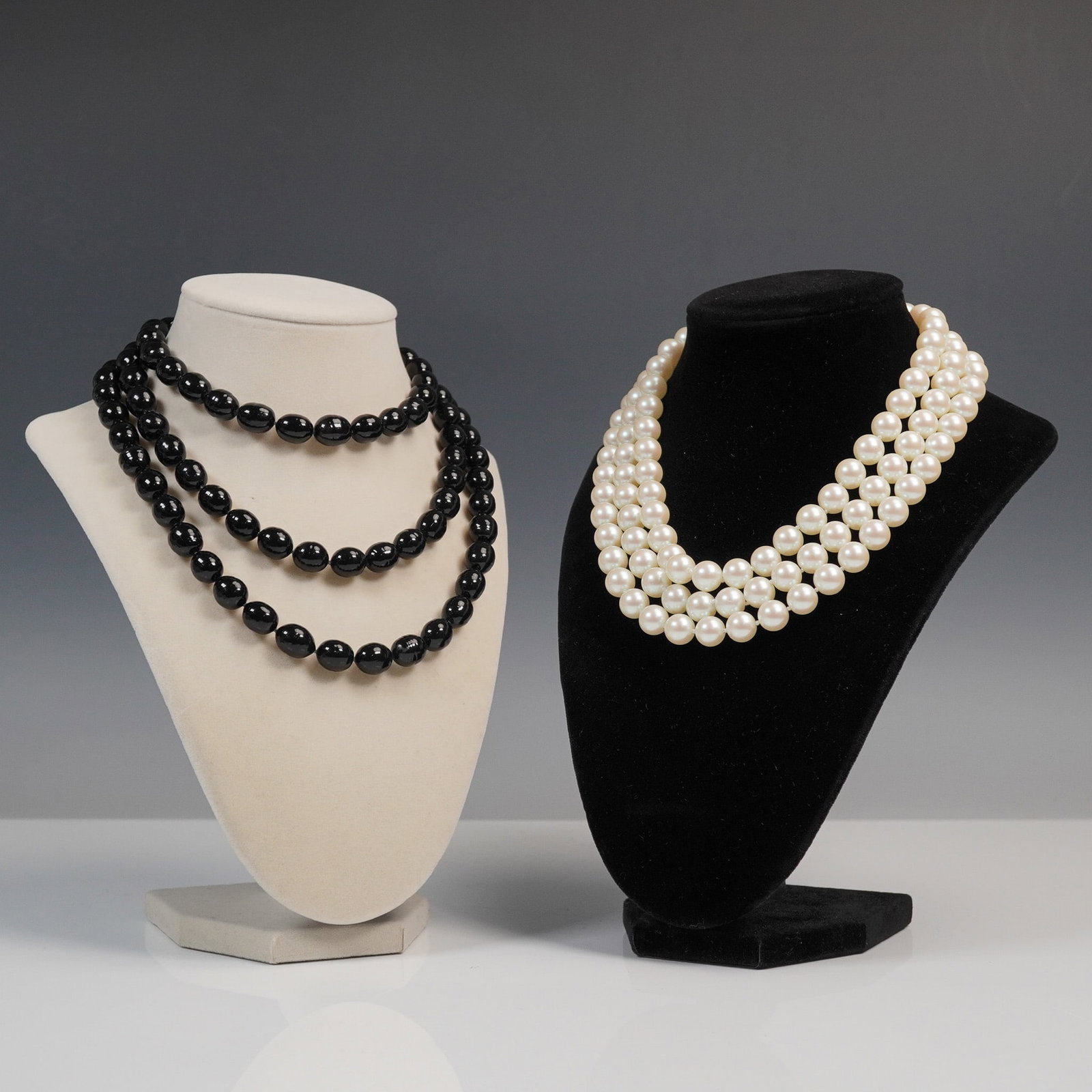 2pc Faux Pearl and Black Bead Costume Necklaces: Two costume necklaces featuring bold beadwork and rhinestone-accented clasps. Includes a triple strand faux pearl necklace with a rhinestone clasp, measuring approximately 16.25"L from clasp to clasp,