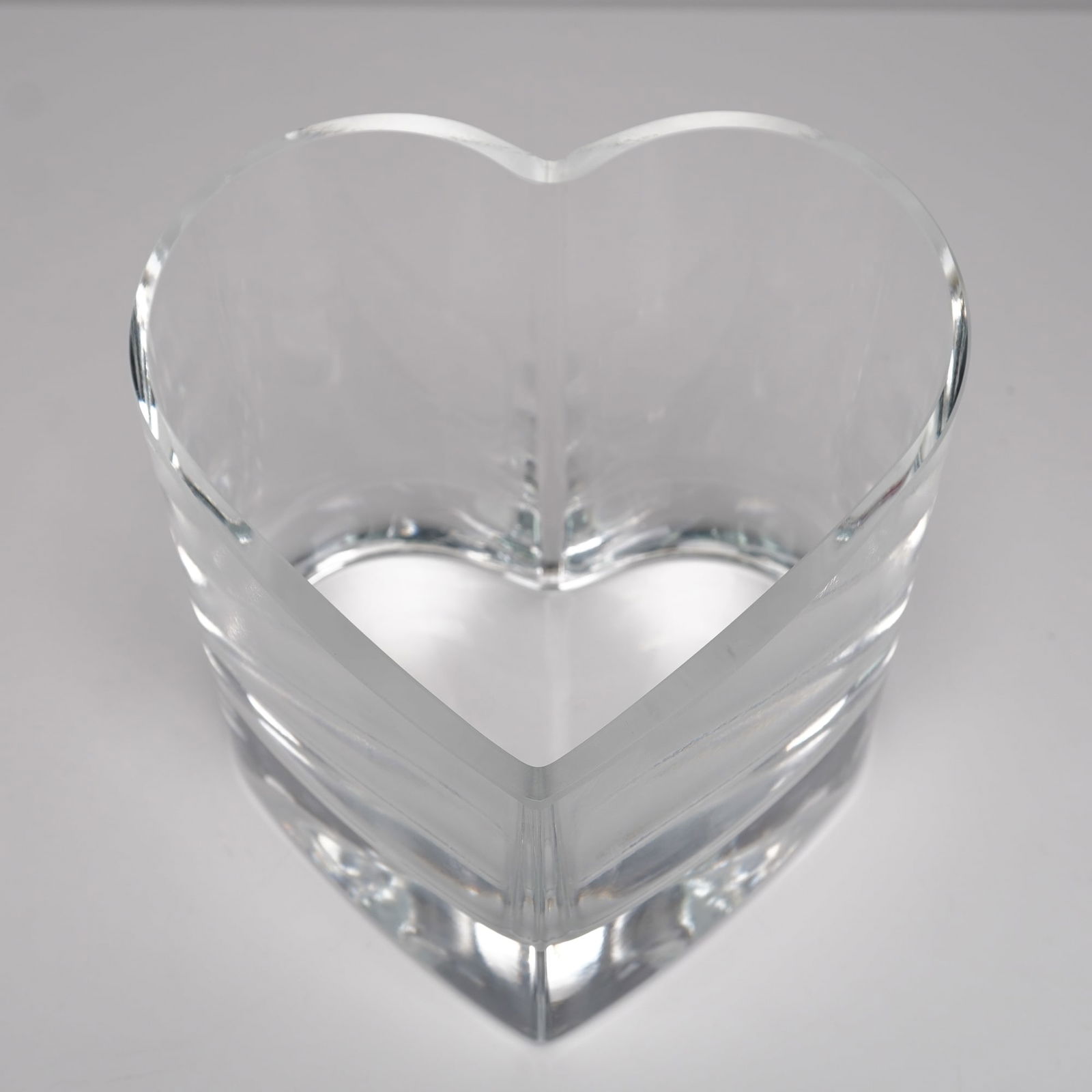J. Badash Signed Crystal Heart-form Dish: A modern heart-shaped crystal candy or trinket dish by J. Badash, signed along the side in script. The thick-walled form features smooth sculptural lines and a flat-polished base, designed to refract