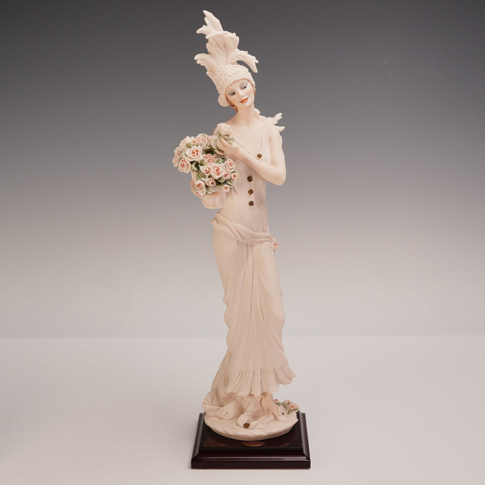 Giuseppe Armani Florence Figurine, Pamela: Giuseppe Armani Florence figurine titled Pamela, crafted in 1999. This elegant sculpture depicts a tall Art Deco-style lady adorned in a flowing ivory gown with ruffle details and golden buttons. She 