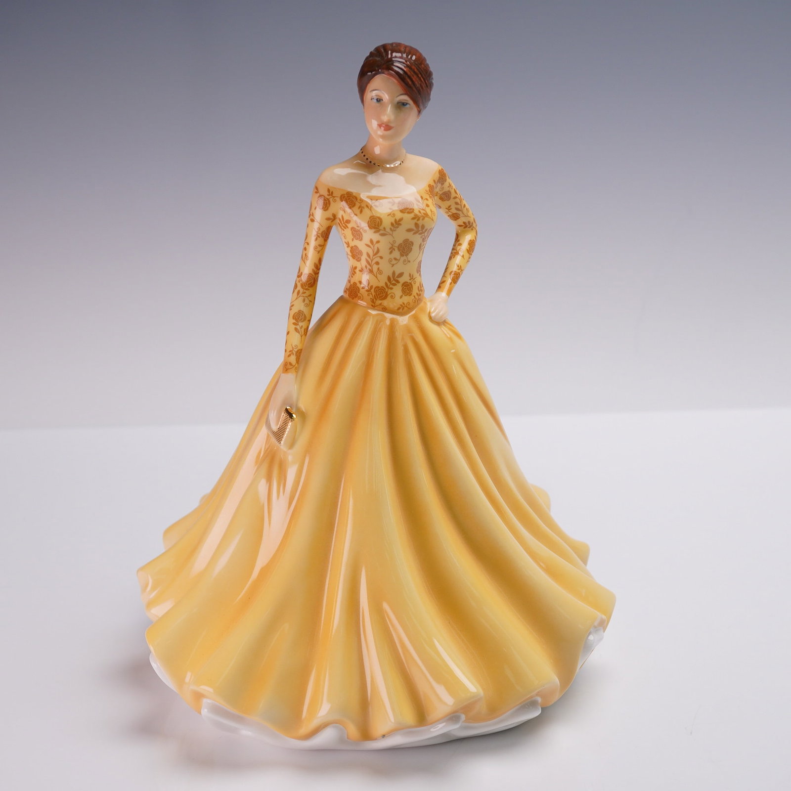 Royal Doulton Figurine, Jane HN5928: Charming Royal Doulton figurine titled Jane, HN5928, from the Michael Doulton Exclusive 2020 collection. Designed by Neil Faulkner, this elegant bone china figure features a lady in a rich golden gown