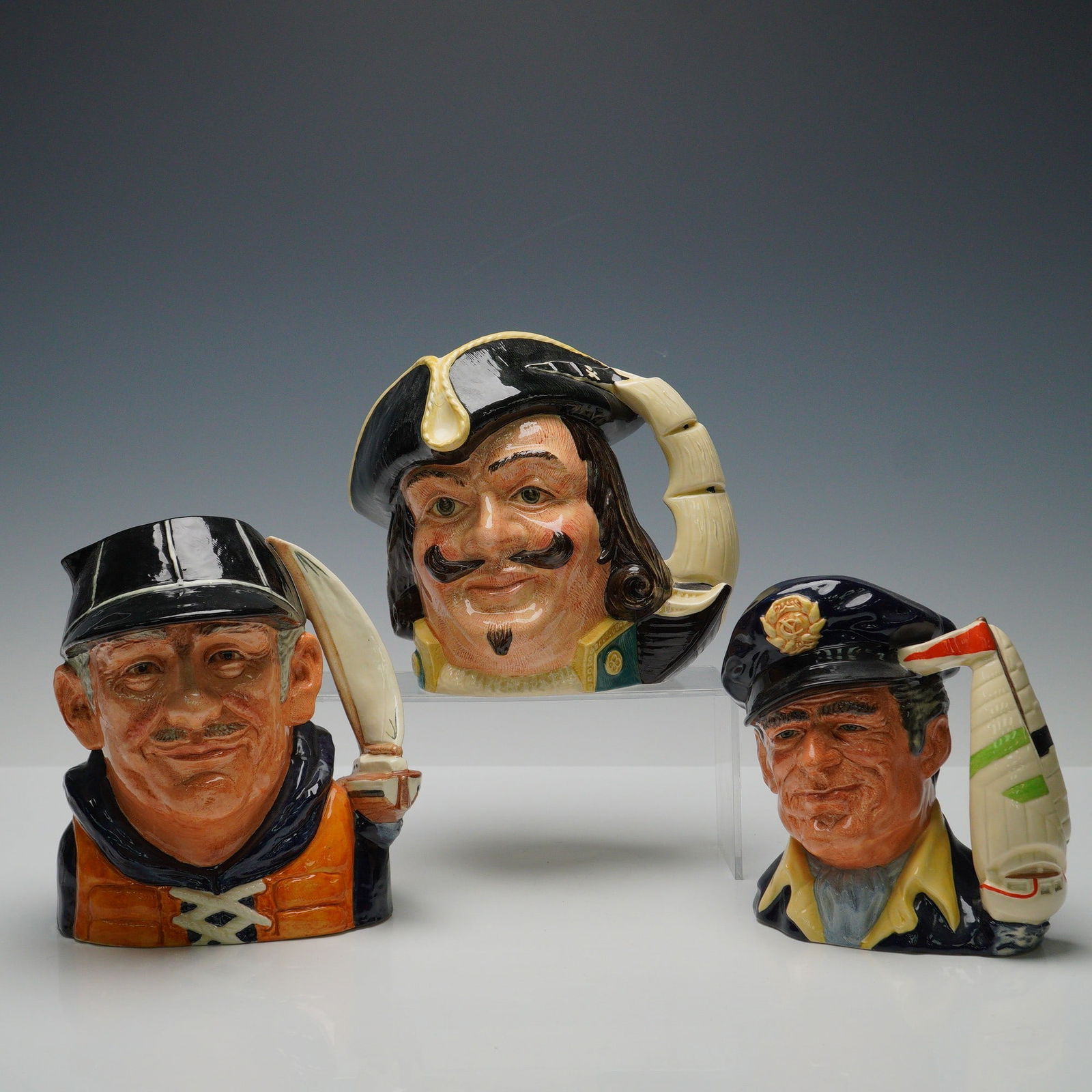 3pc Royal Doulton Nautical Theme Character Jugs: A group of three Royal Doulton character jugs including The Yachtsman (D6622) designed by David B. Biggs, The Yachtsman (D6820) designed by Stanley J. Taylor, and Captain Henry Morgan (D6467) designed