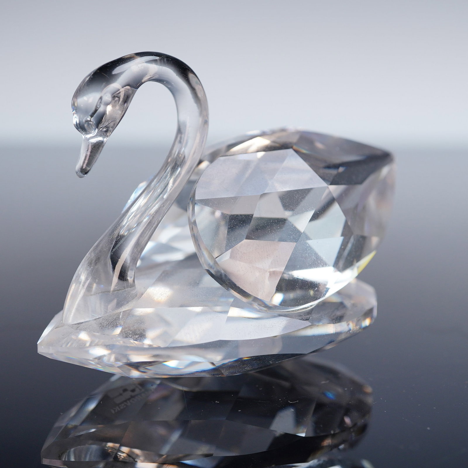 Swarovski Crystal Figurine, Swan: Elegant Swarovski crystal figurine in the form of a swan, featuring a clear faceted body with smooth neck and head detail. The precision-cut facets reflect light beautifully, showcasing Swarovski's re