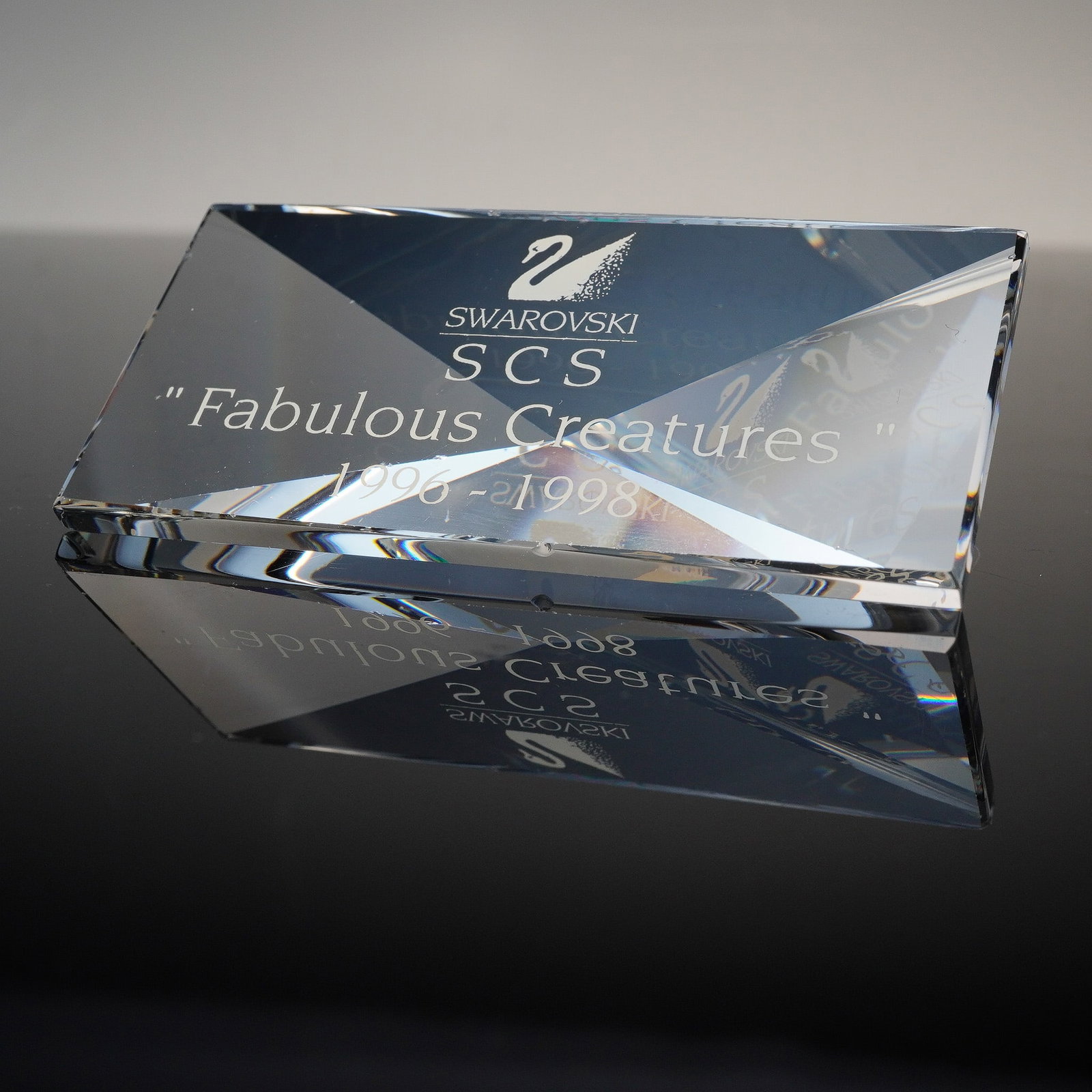 Swarovski Crystal Figurine, Fabulous Creatures Plaque: This Swarovski Crystal plaque commemorates the SCS trilogy series titled Fabulous Creatures, which ran from 1996 to 1998. Crafted in clear faceted crystal, it features the etched Swarovski swan logo, 