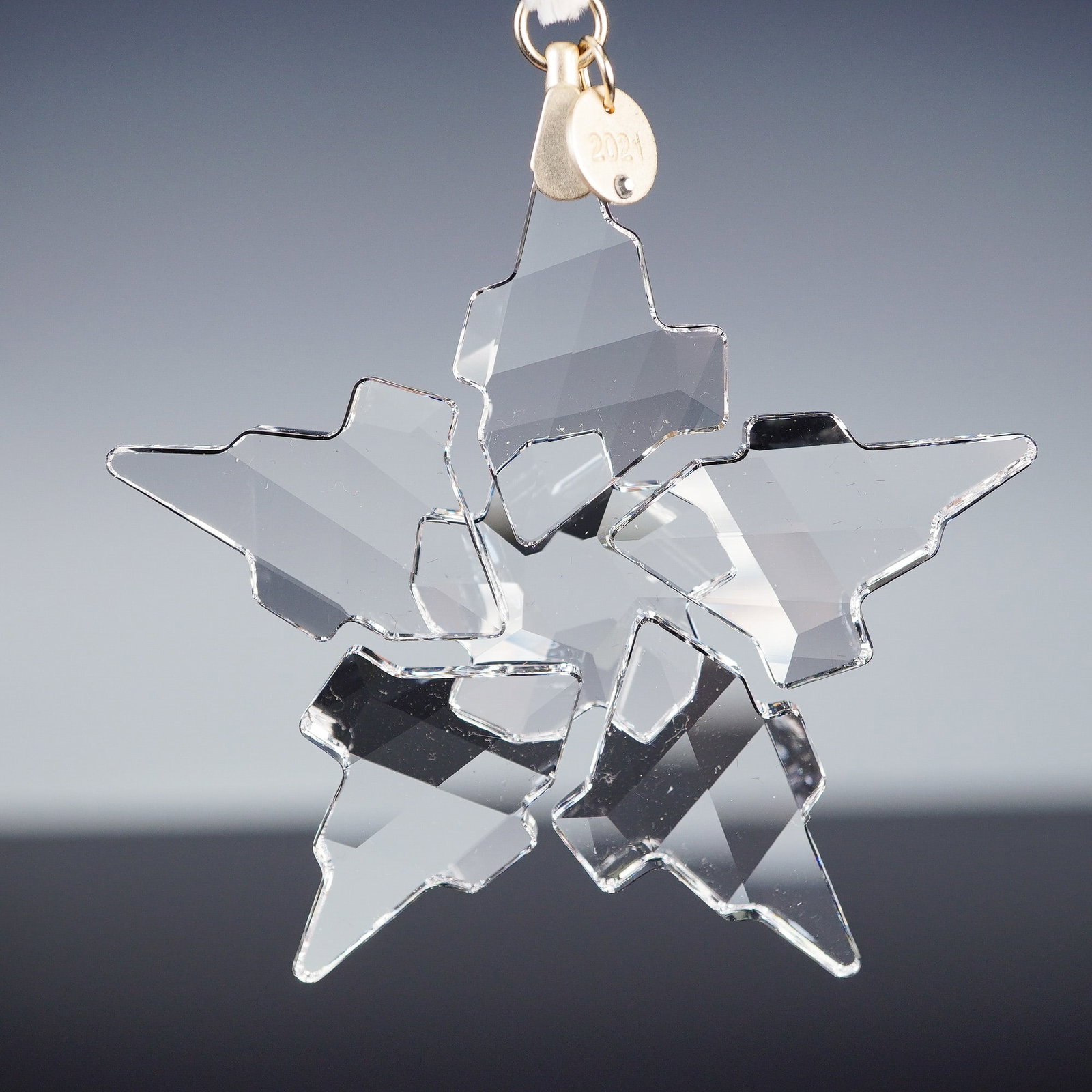 Swarovski Crystal Ornament, Christmas Snowflake 2021: Marking the 30th anniversary of Swarovski's Annual Edition Ornament tradition, this 2021 design by Michele Blasilli showcases a striking modern interpretation of the classic snowflake. Expertly cut in