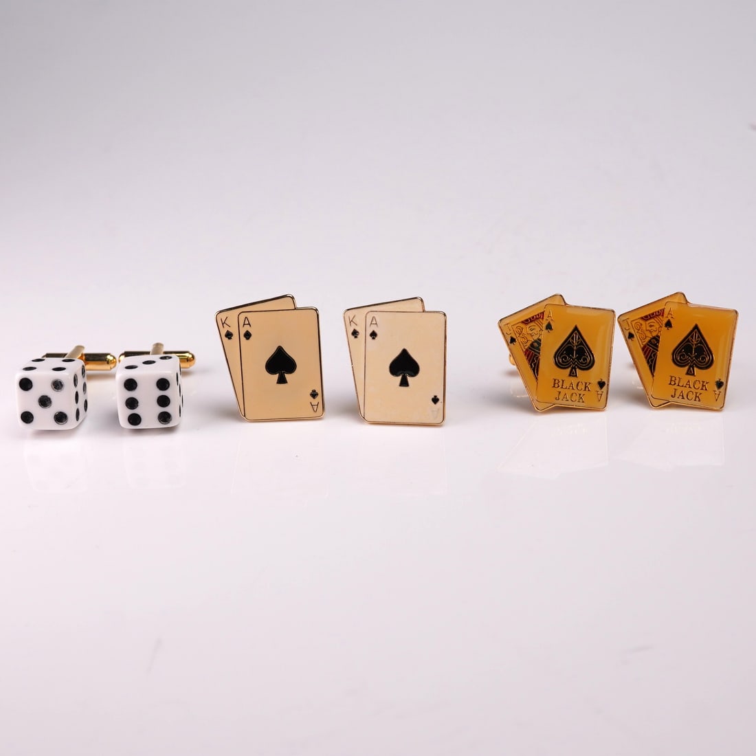 3pc Set Casino Theme Cuff-Links and Button Covers: A playful and stylish 3-piece set featuring two pairs of cuff-links and one pair of button covers inspired by classic casino motifs. The collection includes a pair of white dice cuff-links with black 