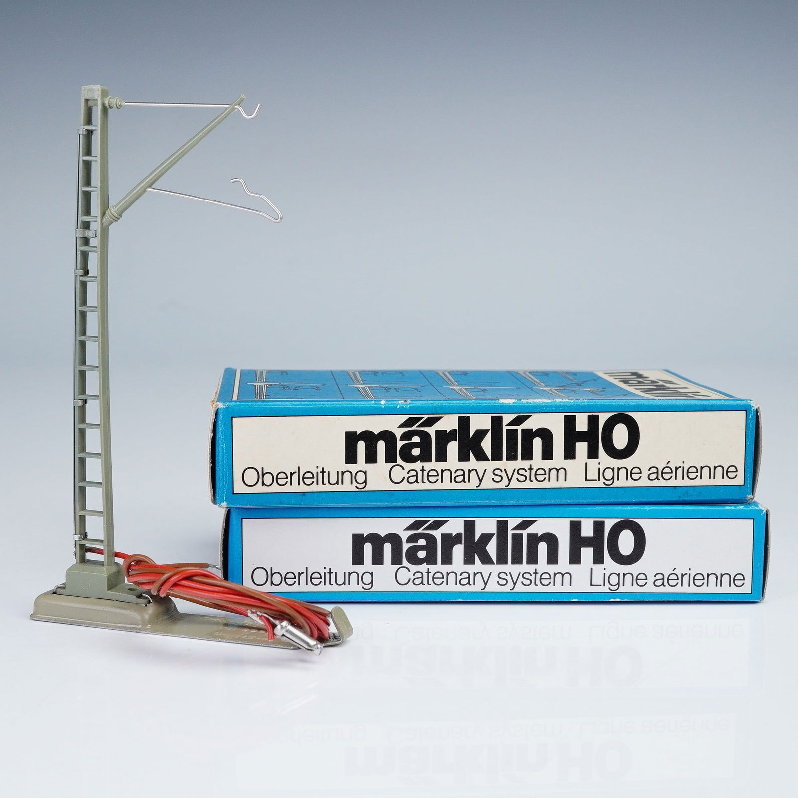 2pc Marklin Catenary System Parts, HO 7010: Marklin HO 7010 M catenary system components, made in Western Germany. Each unit consists of a molded green plastic support mast with ladder detailing, fitted with two metal contact arms designed to h