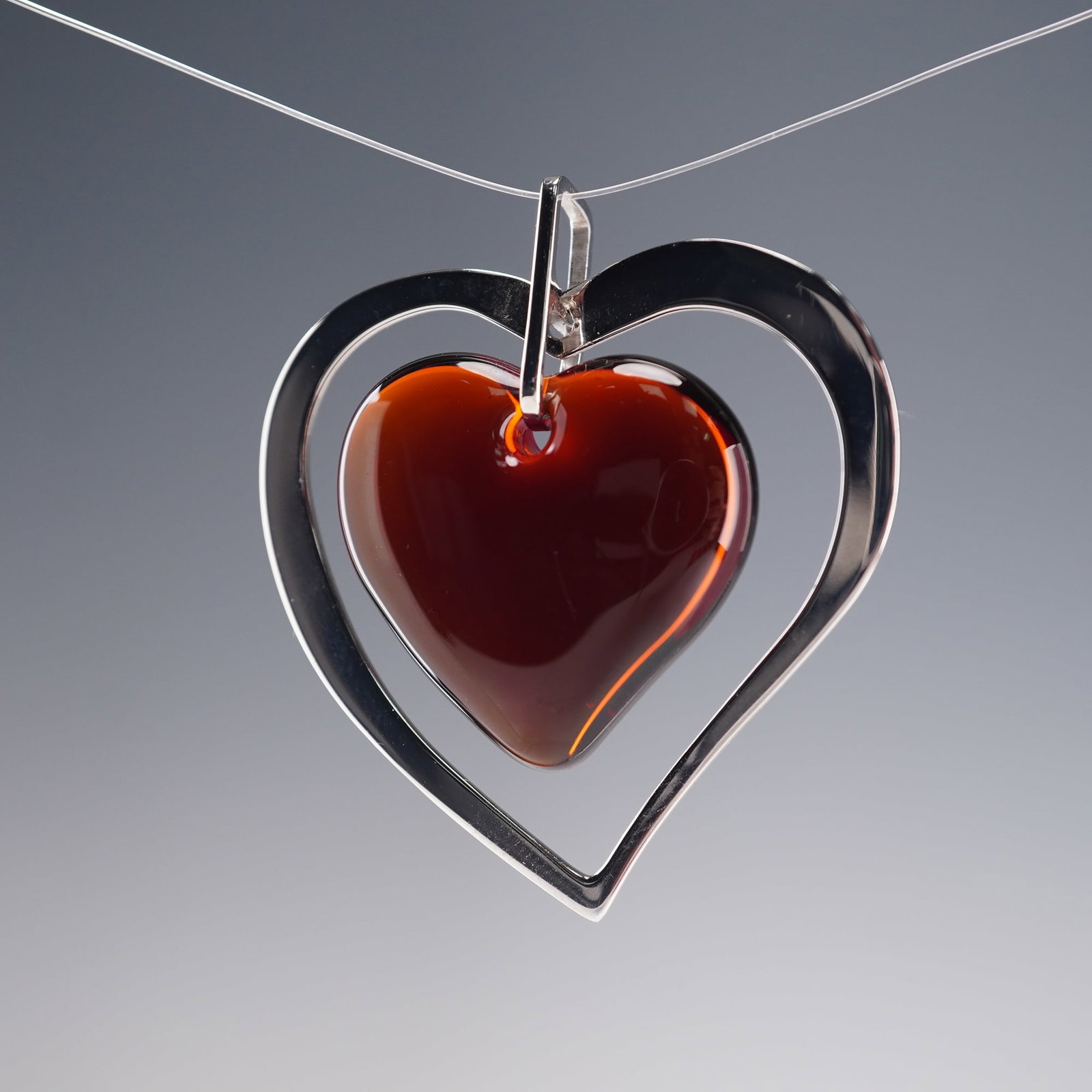 Lalique Sterling Silver Amoureuse Heart Pendant with Red Crystal Center: From the Lalique Amoureuse line, this elegant pendant features a Parma crystal heart mounted in a sterling silver heart frame, symbolizing love and timeless artistry. The design, known as Ajouter a ma