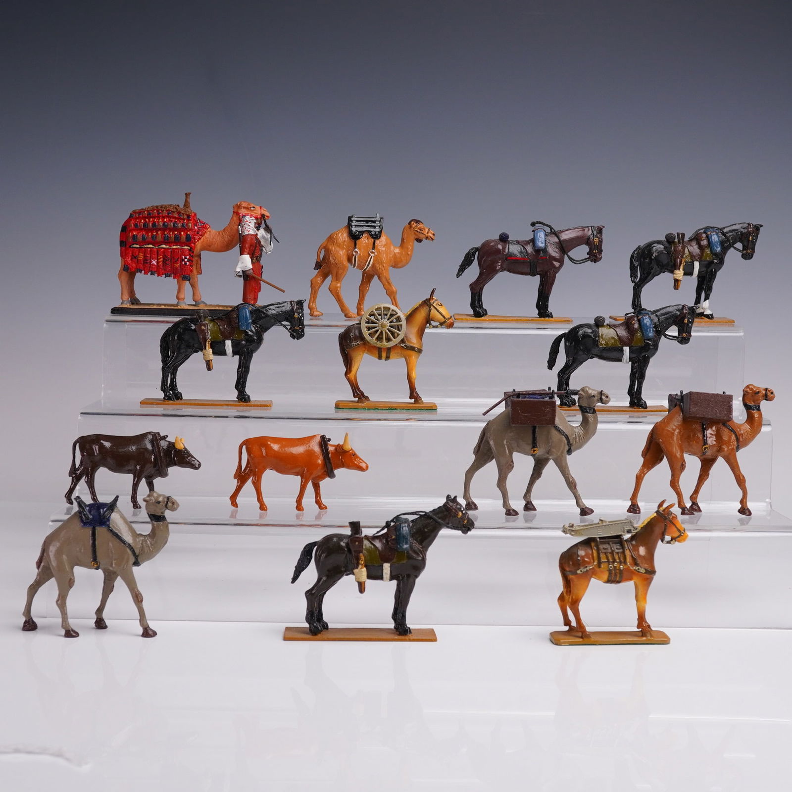 14pc El Templario Metal Pack Animal Figurines: A varied and finely painted assemblage of fourteen lead figures, depicting a selection of pack animals integral to historical and military logistical operations. Included are camels adorned with detai