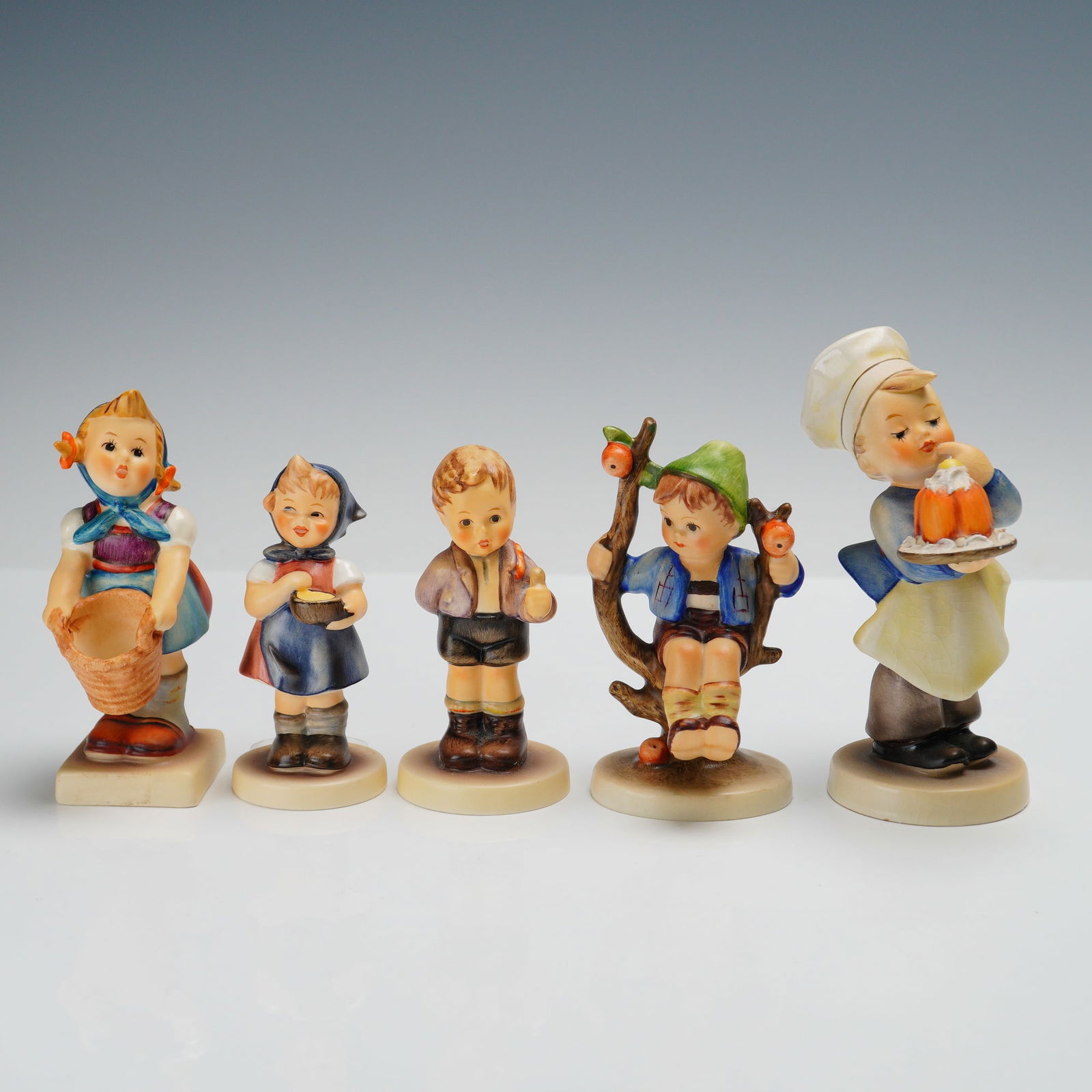 5pc Goebel Hummel Porcelain Figurines: Collection including 'Baker' (128), 'Little Helper' (73), 'Apple Tree Boy' (142 3/0), 'No Thank You' (535), and 'From Me To You' (629). Each piece is marked with the Goebel backstamp and has the M.I.