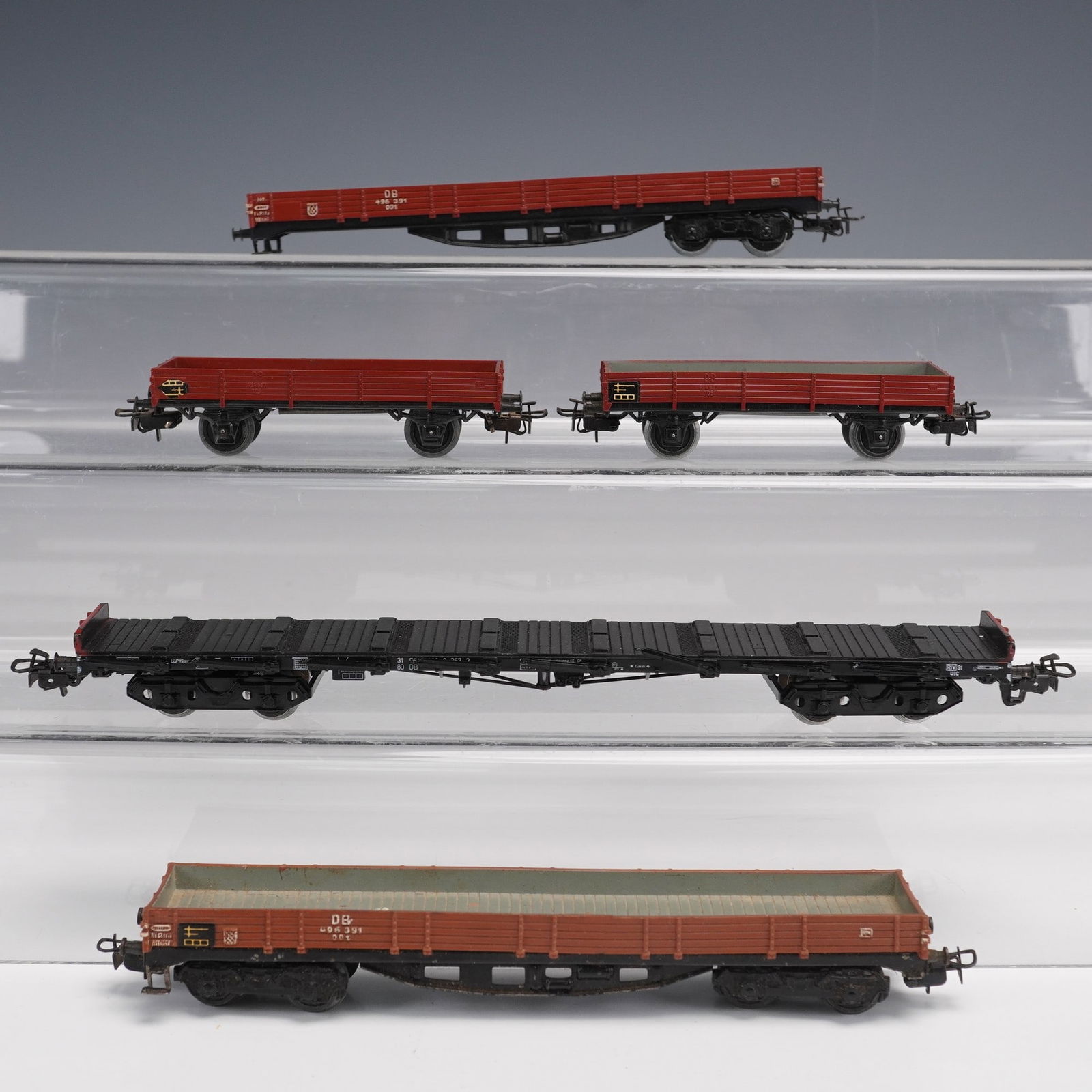 5pc vintage Marklin HO Model Train Flatbed Freight Cars: This lot features a collection of five vintage Marklin model train flatbed freight cars, all Made in Germany, showcasing the quality and craftsmanship that Marklin is known for. The group includes var