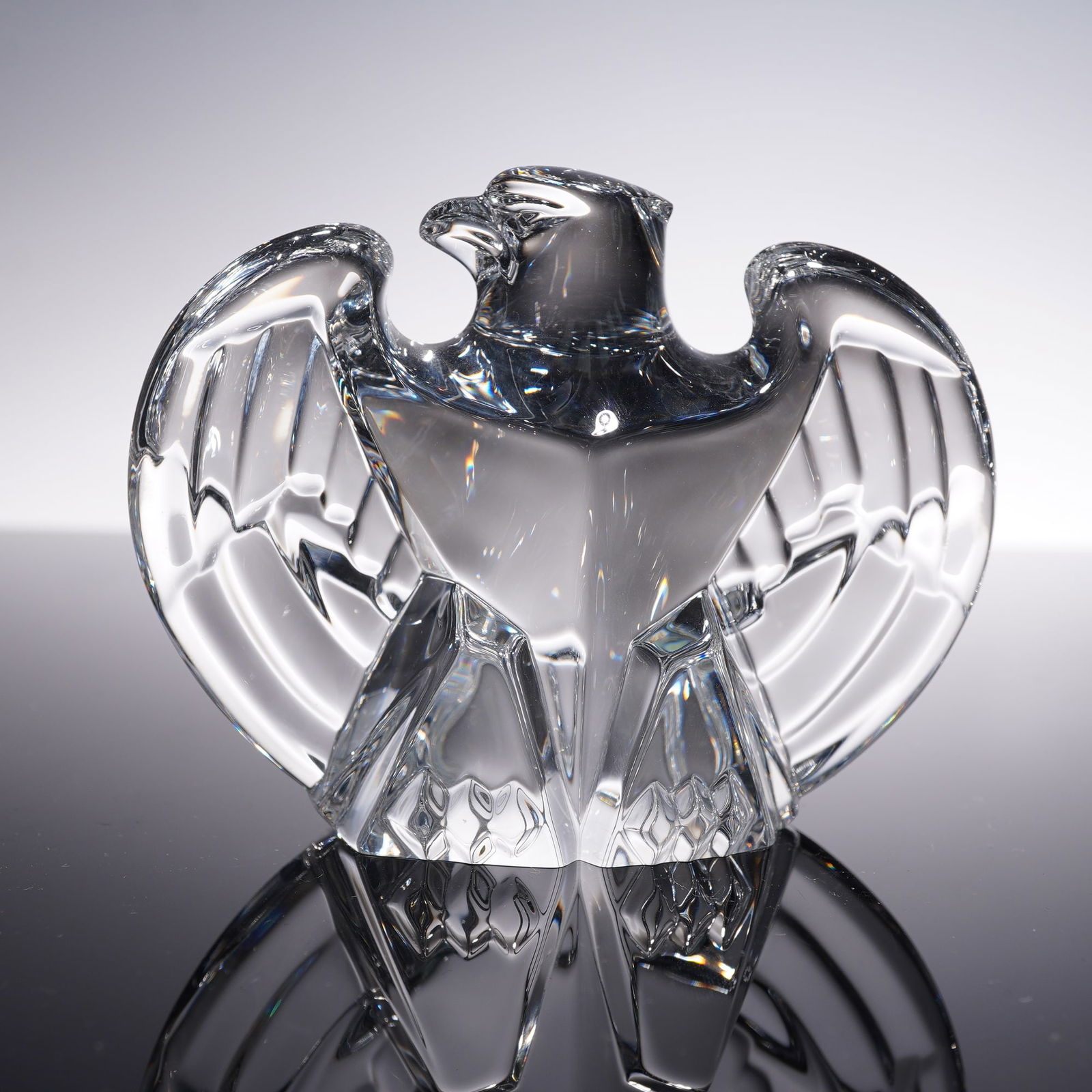 Steuben Crystal Paperweight, Eagle Bird: A finely crafted Steuben clear crystal paperweight in the form of an eagle with wings outstretched. The bold and stylized design captures the strength and grace of the bird in flight, with smooth surf