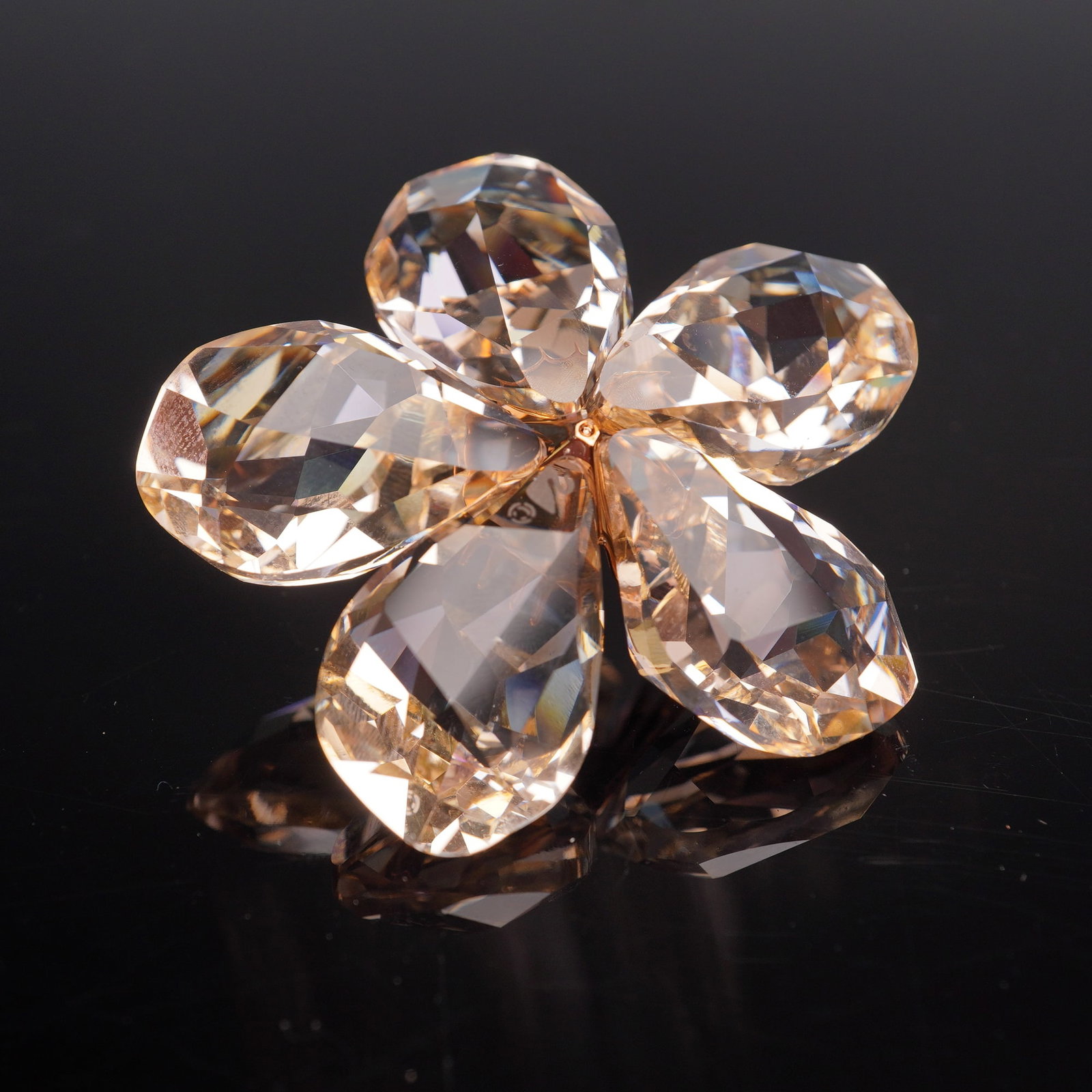 Swarovski Crystal Figurine, Silk Moonlight Diona 956809: This Swarovski figurine features a graceful flower design with petals in warm champagne crystal that sparkle beautifully in the light. The rose gold toned setting enhances the brilliance of each facet