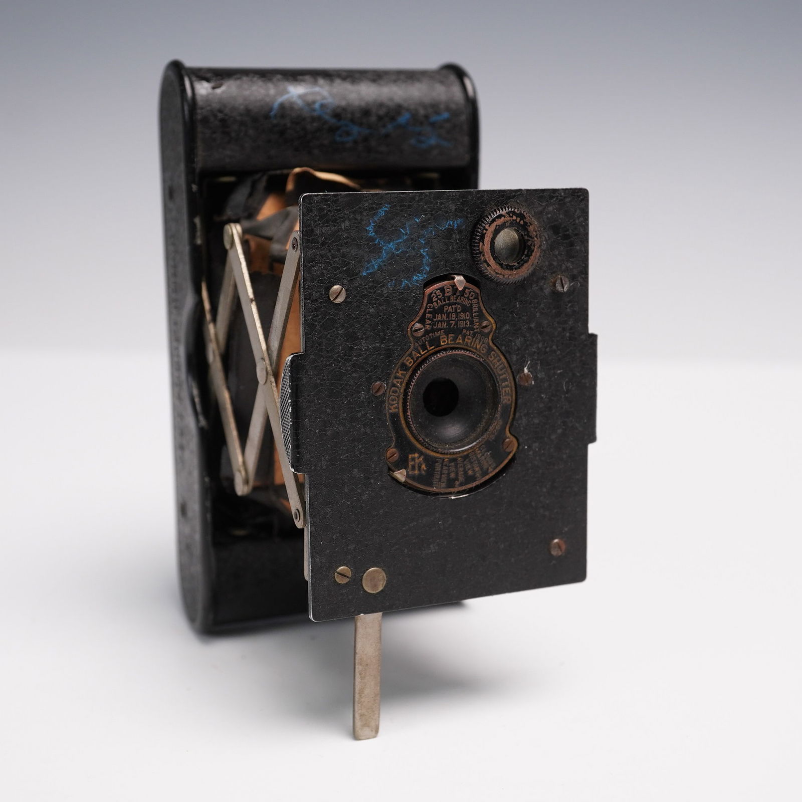 Vest Pocket Kodak Model B Folding Camera: Vintage Vest Pocket Kodak Model B camera featuring a compact folding design with bellows and ball bearing shutter. Marked with Kodak Ball Bearing Shutter and equipped with multiple exposure settings i