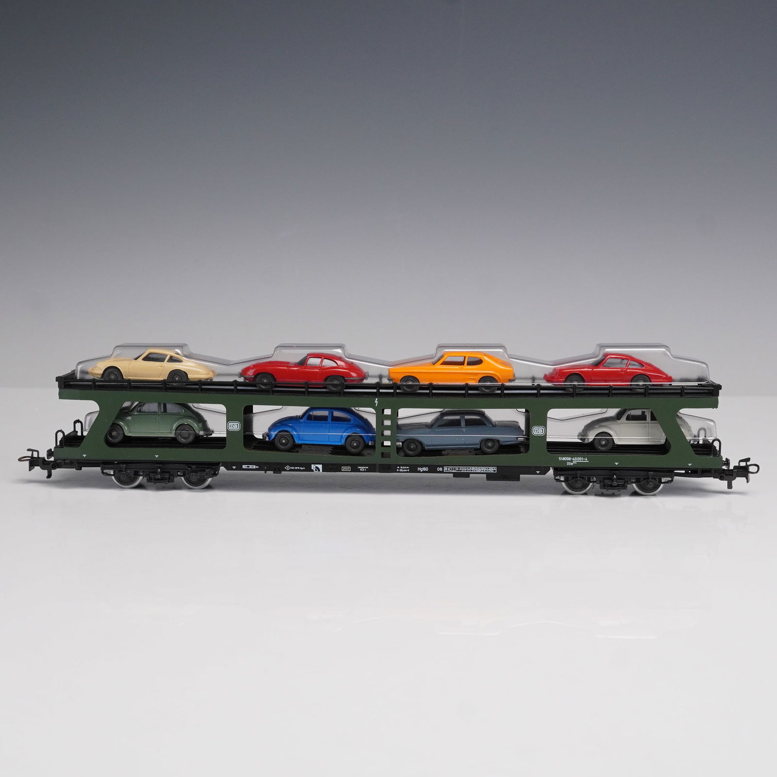 Marklin Collectible, Car Transporter HO4074: A double-deck car transporter freight car. The model features a dark green frame with black detailing, Deutsche Bundesbahn markings, and fine printed specifications along the base. The transporter com