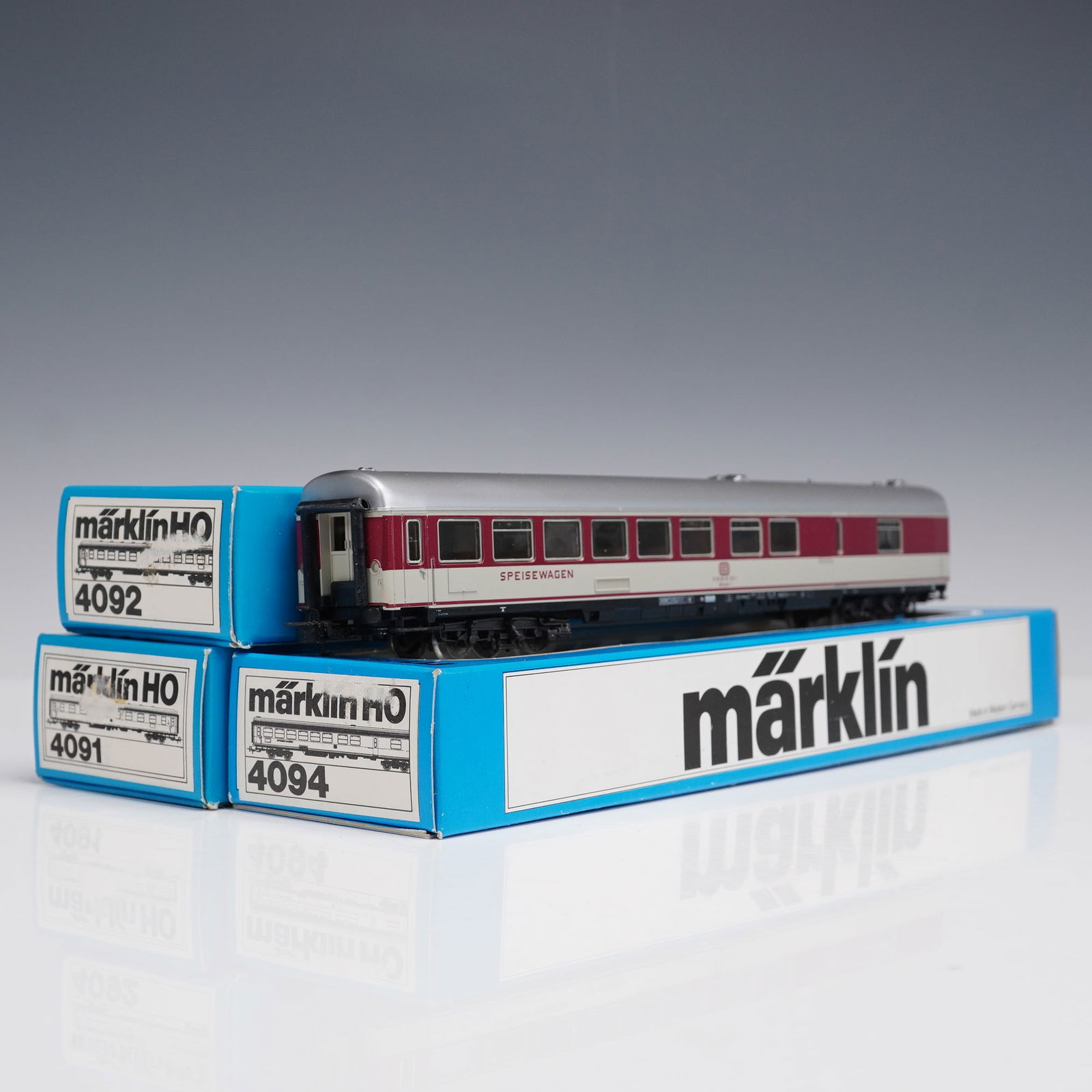 3pc Vintage Marklin HO Scale DB Passenger Cars: This lot offers three Marklin HO scale German passenger train cars, each crafted with the precision and quality Marklin is renowned for and marked "Marklin - Made in Germany." The set includes two Deu