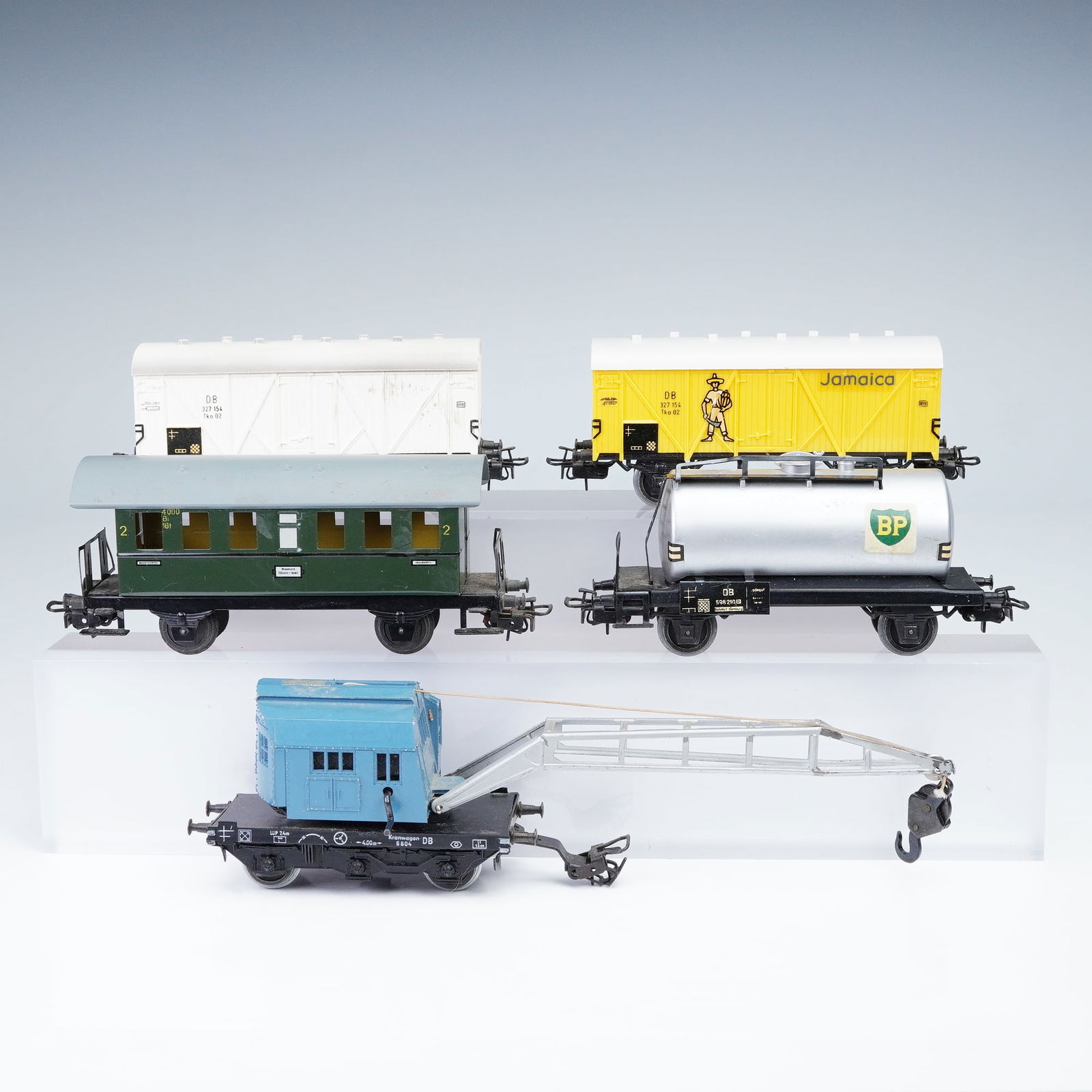 5pc Marklin HO Scale German Freight and Crane Train Cars: This lot features five vintage Marklin HO scale German train cars, showcasing a variety of classic freight and utility styles, all marked "Germany" on the underside. Included are two bright freight ca
