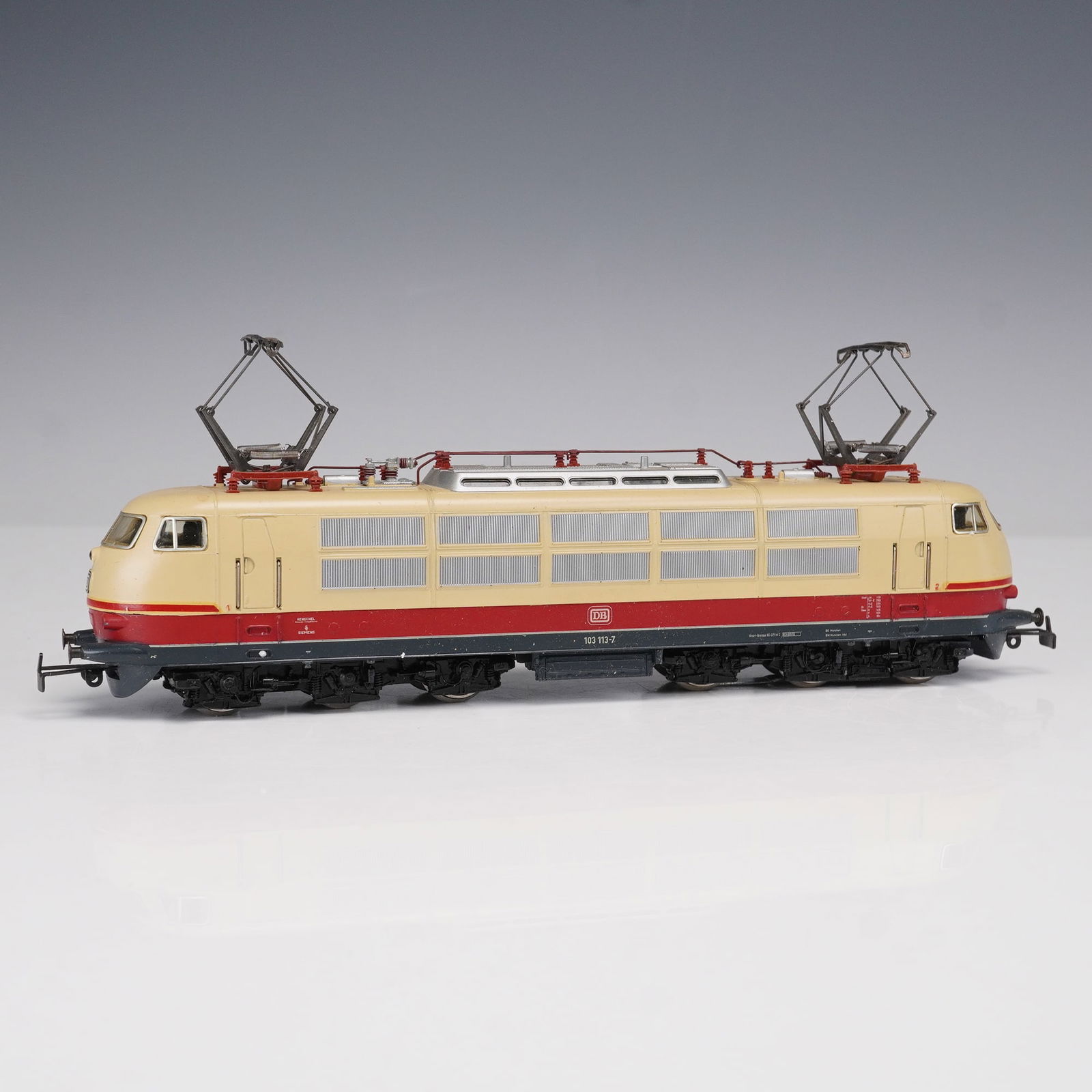 Marklin Model Locomotive, 8854 DB Class 103 Electric Locomotive: Marklin HO scale model electric locomotive, catalog number 3054, representing the DB Class 103 in beige and red livery. The locomotive is marked with road number 103 113-7 and features dual pantograph