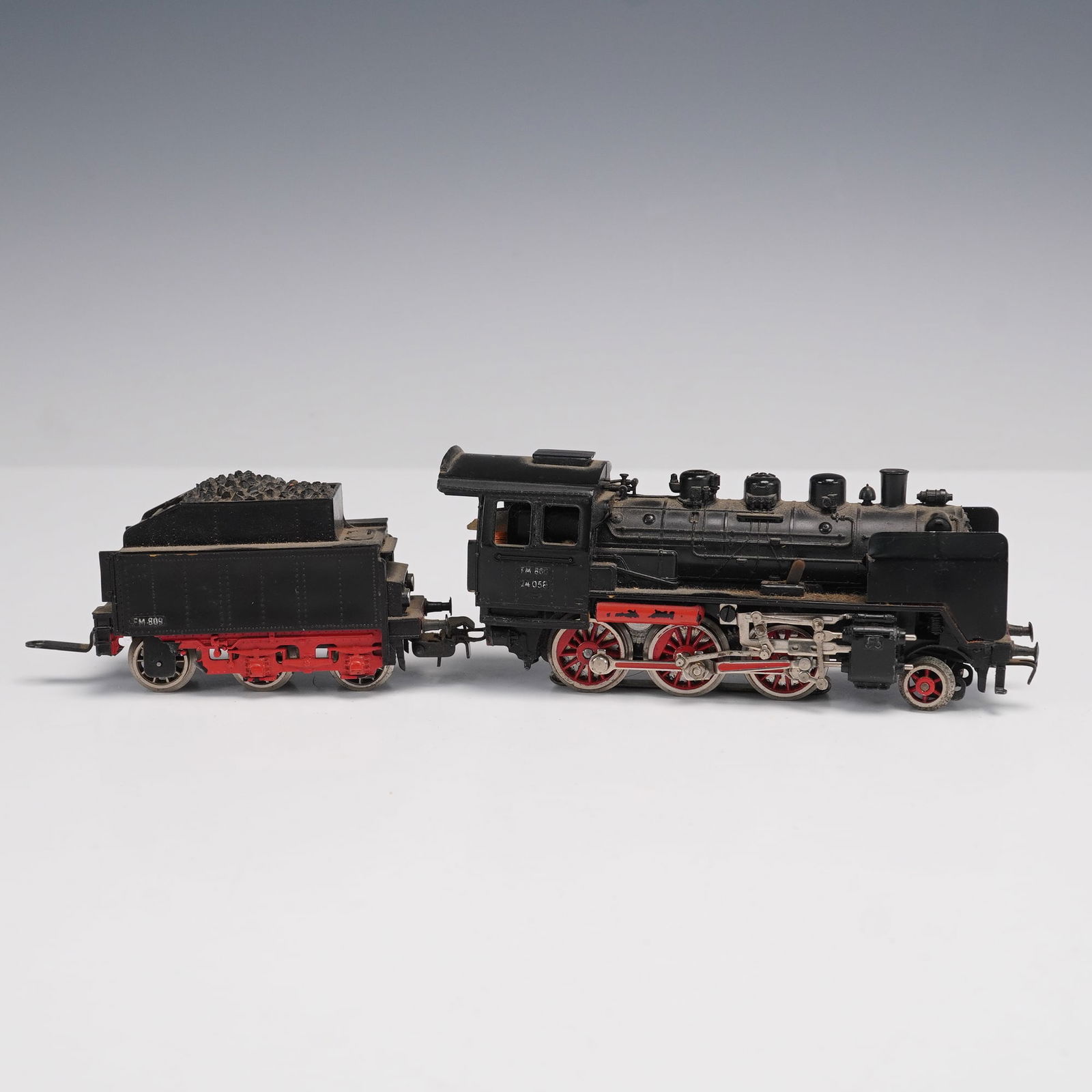 2pc Vintage Marklin HO Scale Steam Locomotive and Tender: This vintage Marklin model steam locomotive and tender set, marked "Made in Germany," is a finely crafted piece from the renowned German model train maker Marklin. The locomotive carries the model num