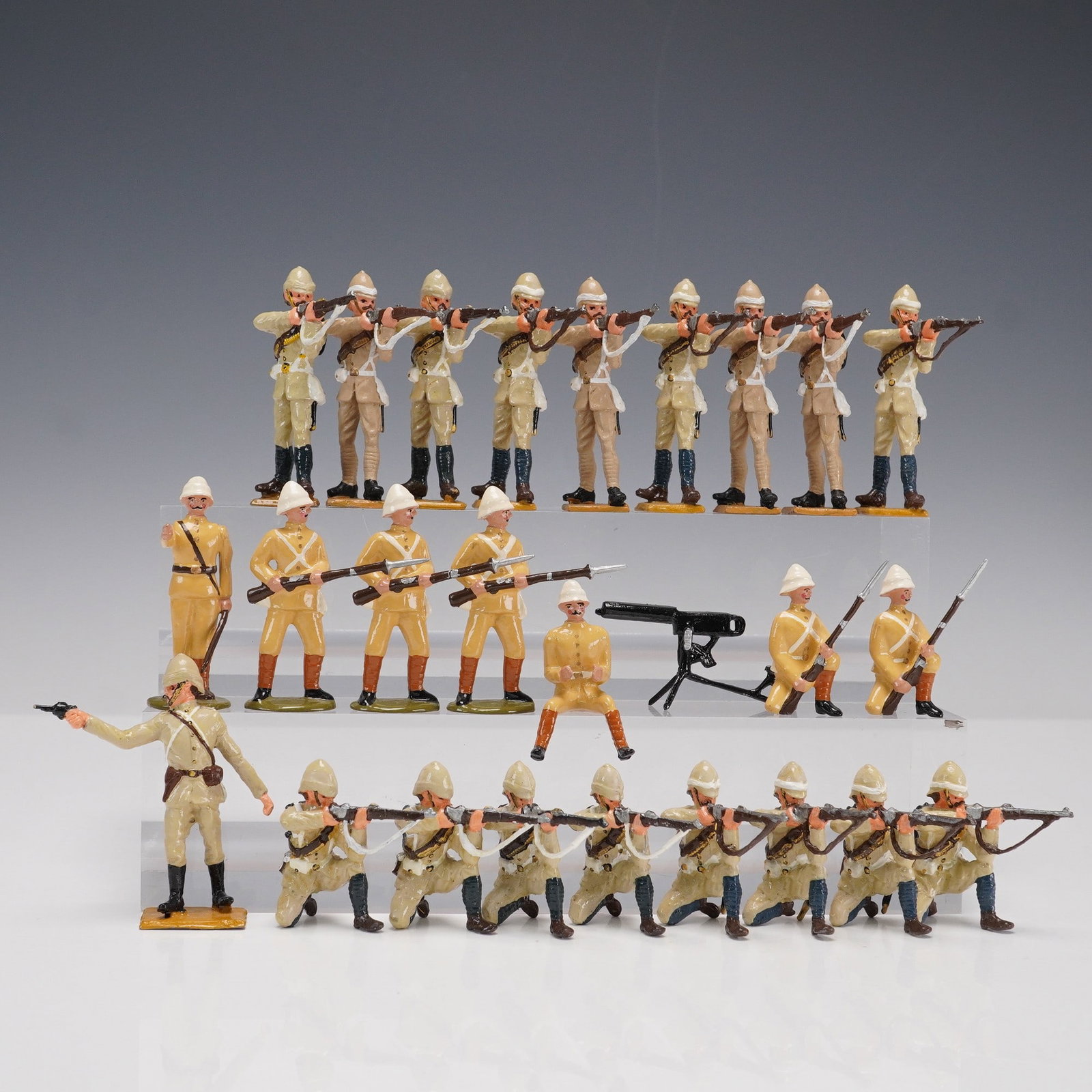 26pc Painted Colonial-Era Military Figurines with Machine Gun: Twenty-six hand-painted cast metal military-style figures representing colonial-era infantry in various action poses including marching, aiming, kneeling, and commanding. The grouping includes troops 