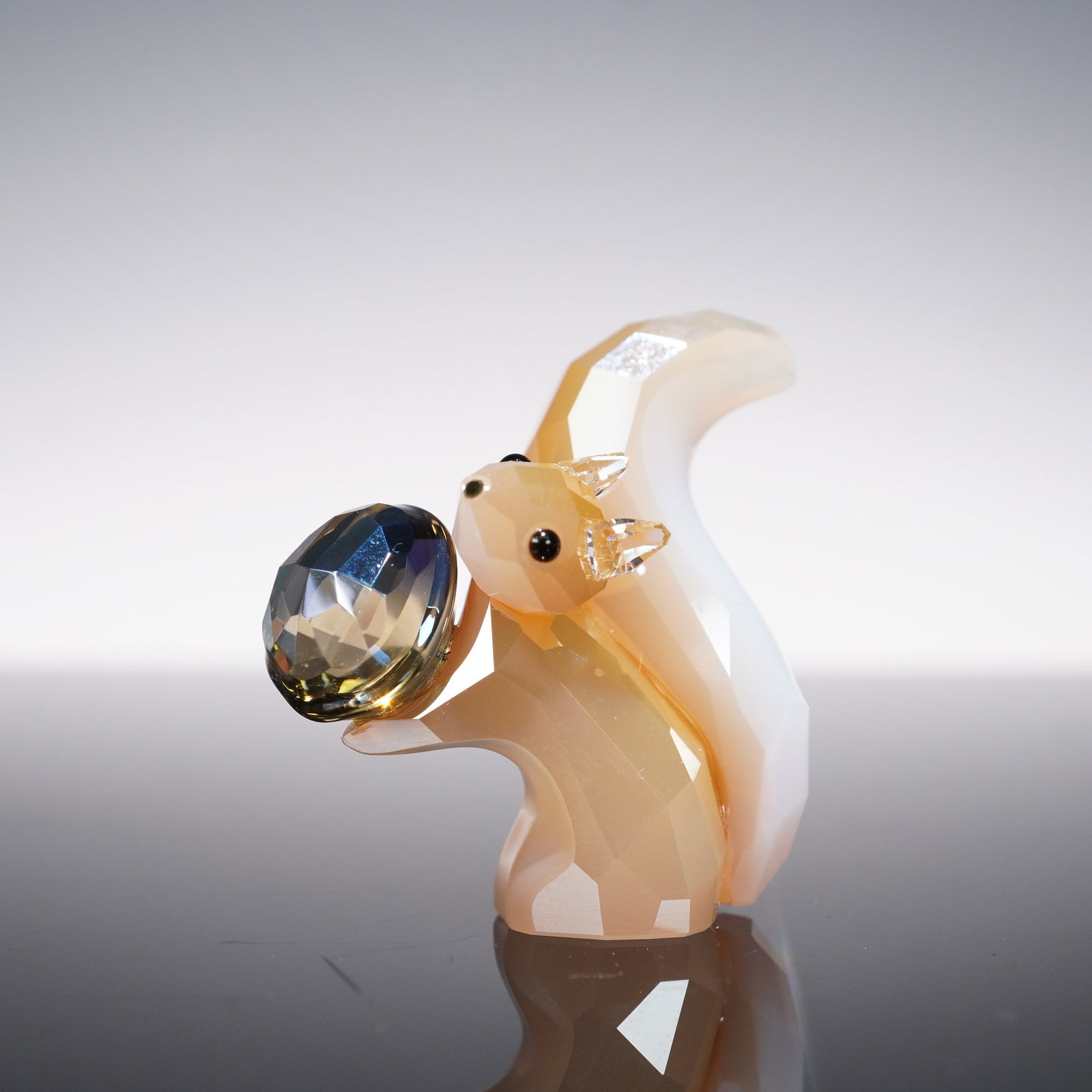 Swarovski Crystal Figurine, Lovlots City Park Gracy the Squirrel: Gracy the squirrel from Swarovski's Lovlots City Park collection is designed in faceted Platinum White crystal, contrasted with clear crystal ears and sparkling Jet crystal eyes. She holds a Smoky Qua