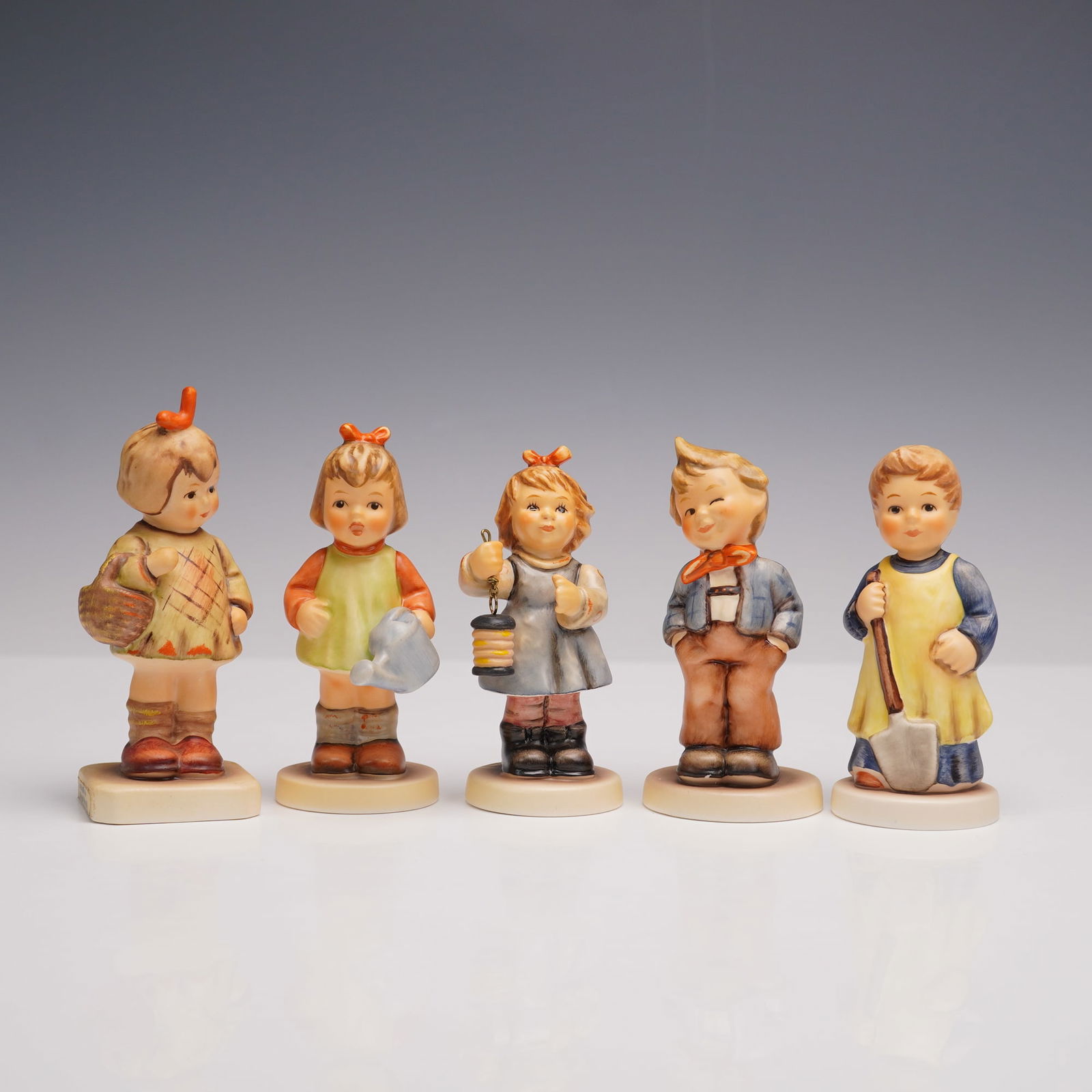 5pc Goebel Hummel Childhood Figurines, Light of Hope and More: Five porcelain figurines depicting children in various activities. The group includes Light of Hope (2233), a girl holding a lantern; Natures Gift (729), a child carrying a basket; I Brought You a Gif