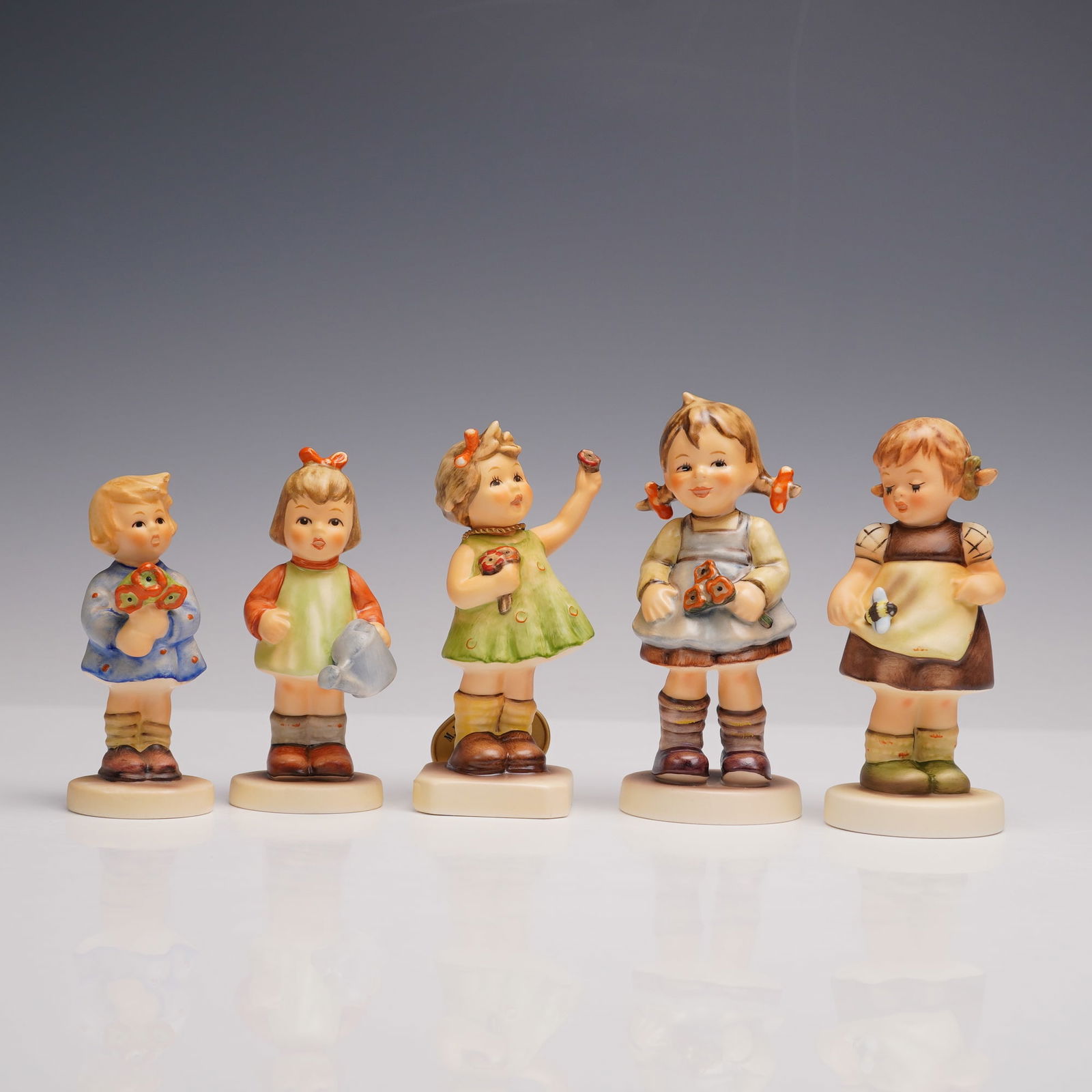5pc Goebel Hummel Porcelain Figurines: A fascinating collection of five hand painted figurines each modeled as young girls with flowers and butterflies, florals, and other poses. Includes Nature's Gift, Forever Yours, Bee My Friend?, Flowe