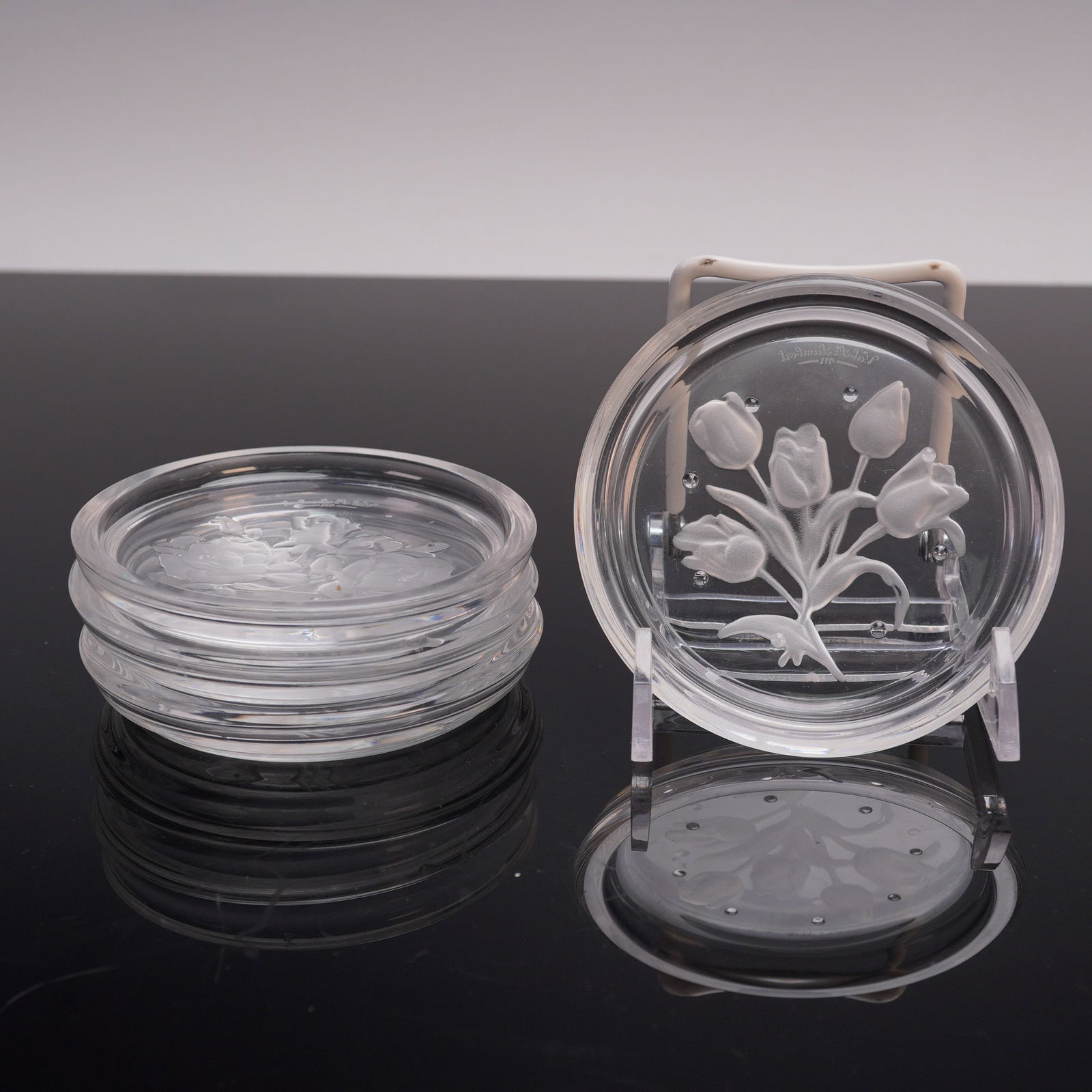 4pc Val St Lambert Floral Coasters: This set of four Val St Lambert coasters features exquisite floral designs, each intricately etched into the crystal surface. Crafted with attention to detail, these pieces are a fine example of the r