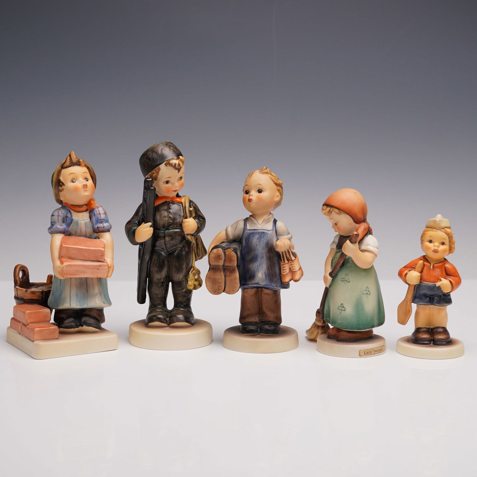 5pc Goebel Hummel Professions Figurines: Includes: Chimney Sweep (12/4/0) carrying ladder and brush, The Builder (305) holding bricks and bucket, Boots (6) with cobbler tools and shoes, Little Sweeper (171/0) with broom, and First Mate (2148