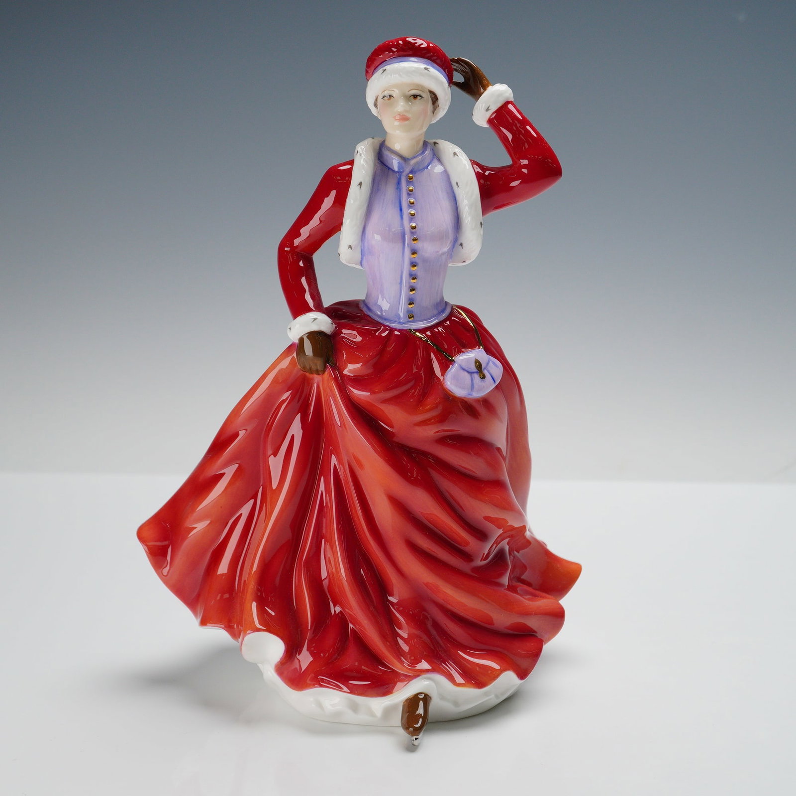Royal Doulton Figurine, Helena HN5518: Royal Doulton figurine titled Helena, HN5518, Lady of the Year 2009, sculpted by John Bromley. The figure depicts a stylish lady in a flowing red gown with a lavender bodice and jacket trimmed in whit