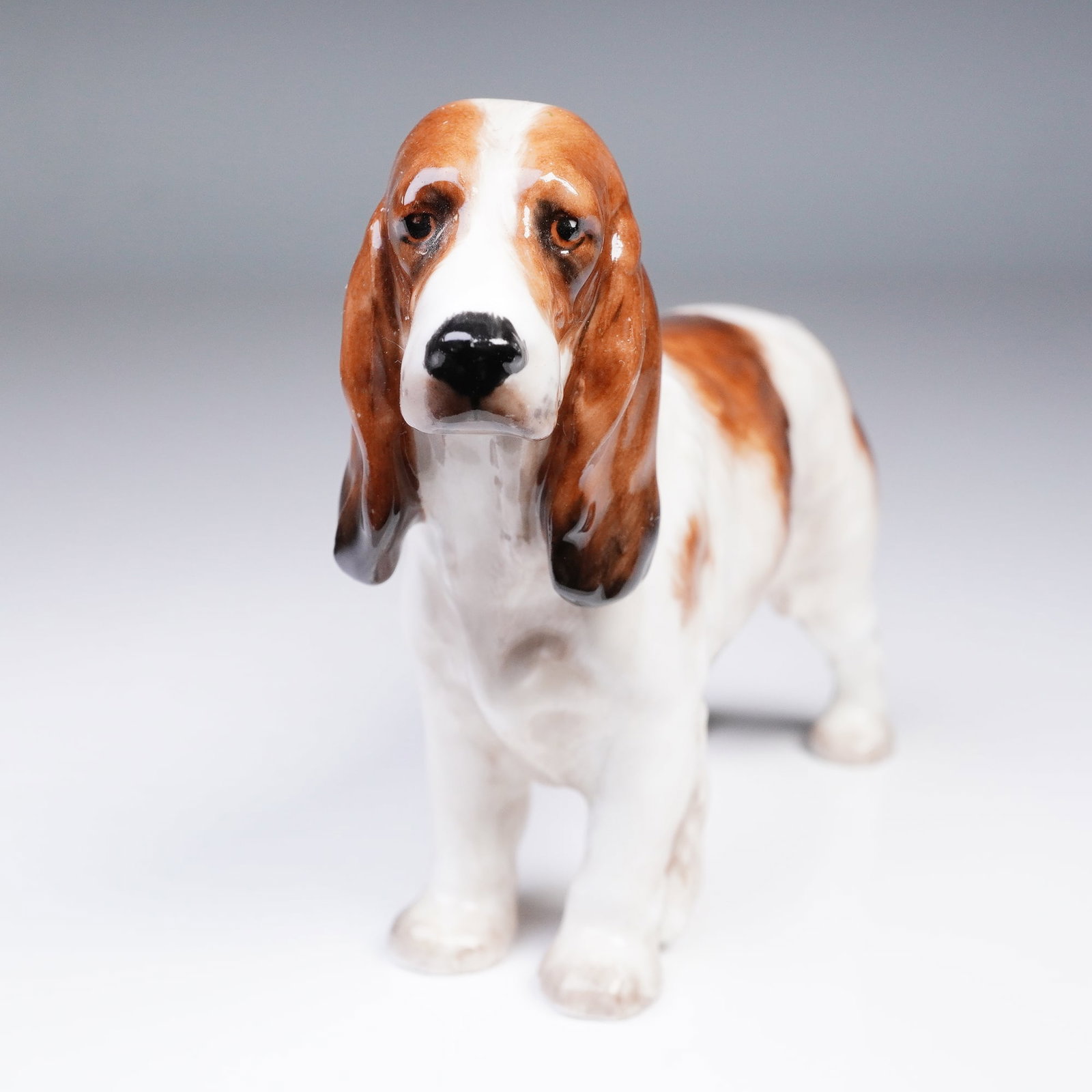 Royal Doulton Figurine, Cocker Spaniel HN1037: With fine detail and lifelike character, this Royal Doulton figurine, model HN1037, portrays a standing cocker spaniel with long drooping ears and an attentive expression. Crafted in bone china and ha