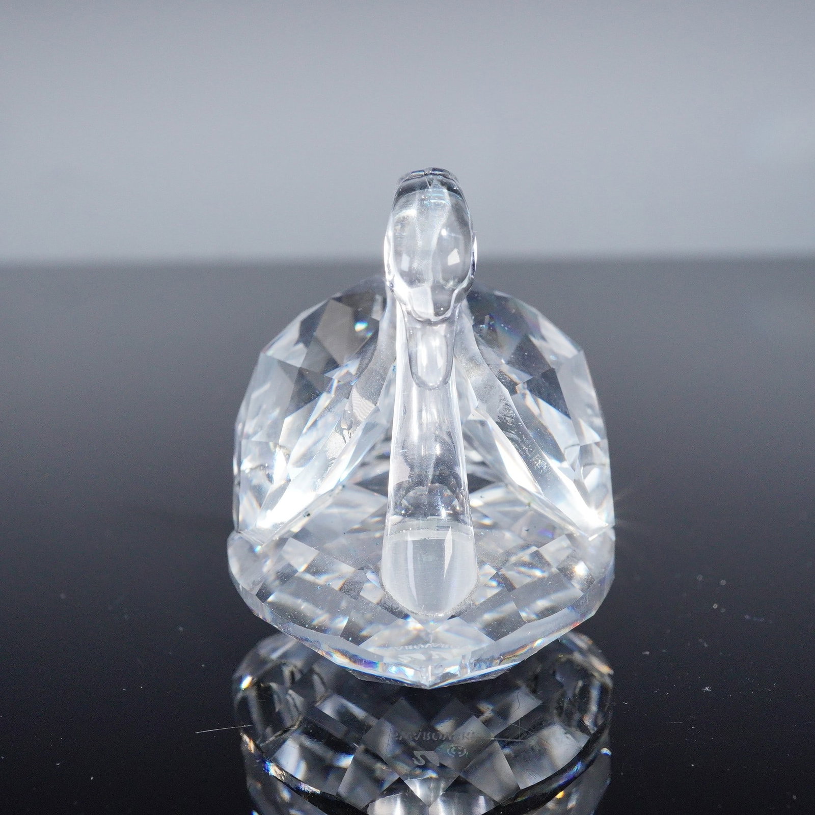 Swarovski Crystal Figurine, Swan: A graceful Swarovski crystal figurine of a large swan, rendered in clear faceted crystal with a smooth curved neck and detailed wings resting on a crystal base. The piece is hallmarked and comes with 