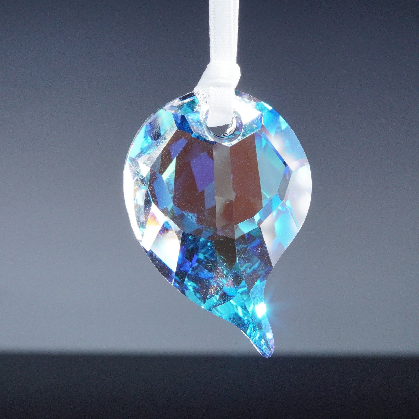 Swarovski Crystal Figurine SCS Ornament Feather: This Swarovski Crystal Society feather ornament was created exclusively for SCS members. It shimmers with a beautiful iridescent brilliance and is accented with a metal pendant engraved with SCS. Mark