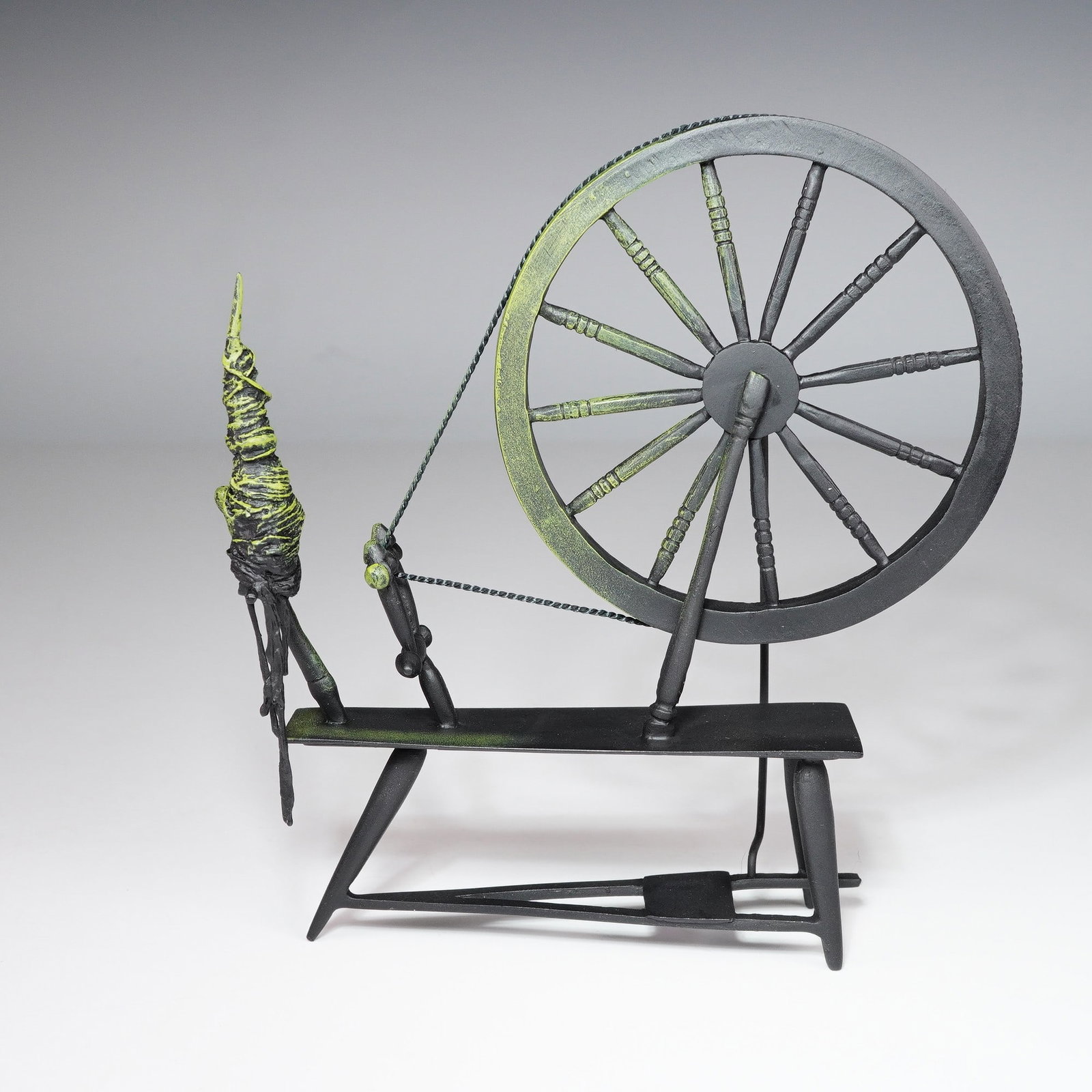 Walt Disney Classics Figurine, Spinning Wheel from Sleeping Beauty: Featured here is a Walt Disney Classics Collection figurine titled Spinning an Evil Spell, showing the Spinning Wheel from Disney's Sleeping Beauty. Rendered in dramatic tones of black and green, this