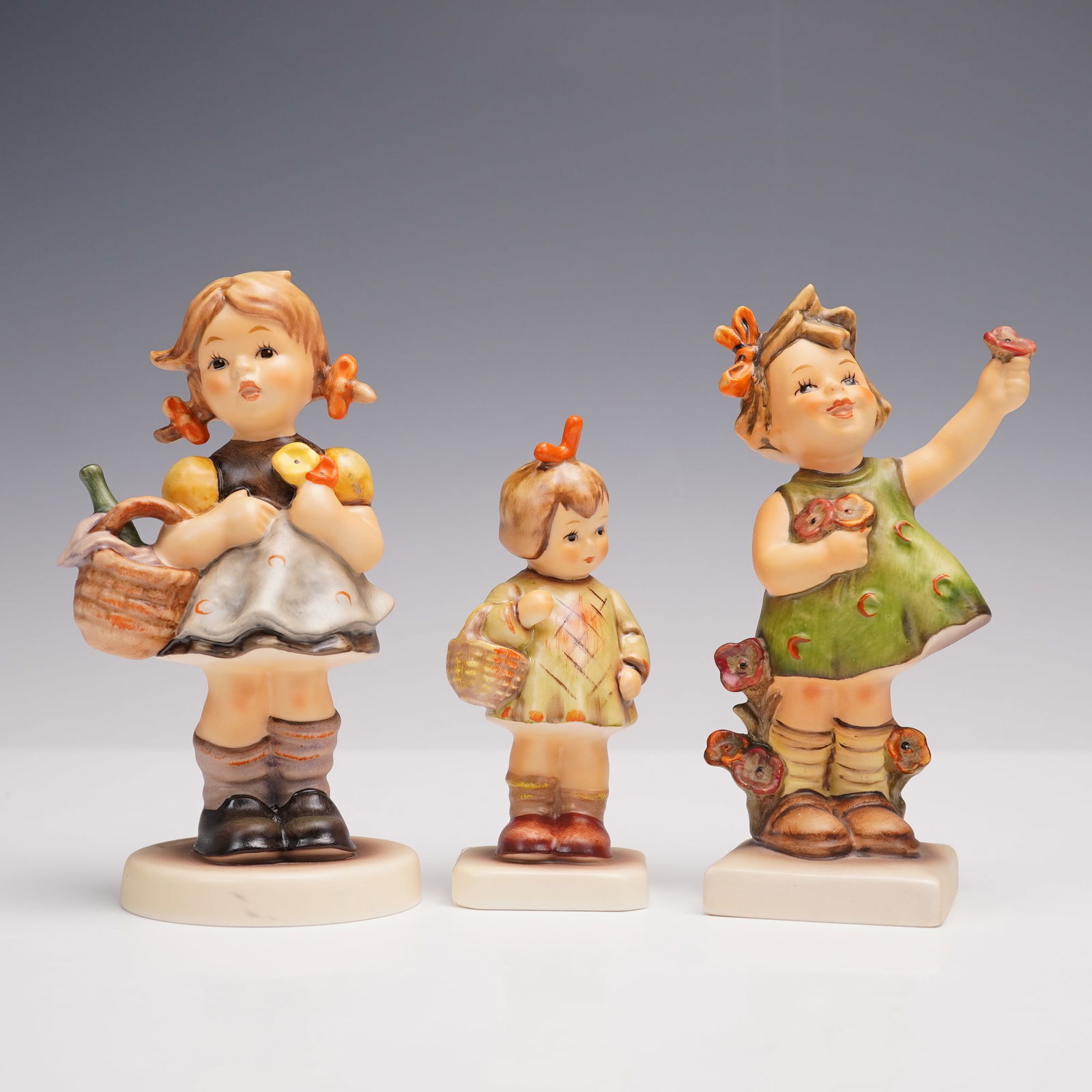 3pc Goebel Hummel Figurines- I Bought You A Gift, Little Visitor & Spring: Set of three charming Goebel M.I. Hummel figurines including I Bought You A Gift (Exclusive Edition TMK-9, M.I. Hummel Club), Little Visitor (TMK-9, M.I. Hummel Club), and Spring Cheer (TMK-6, Goebel