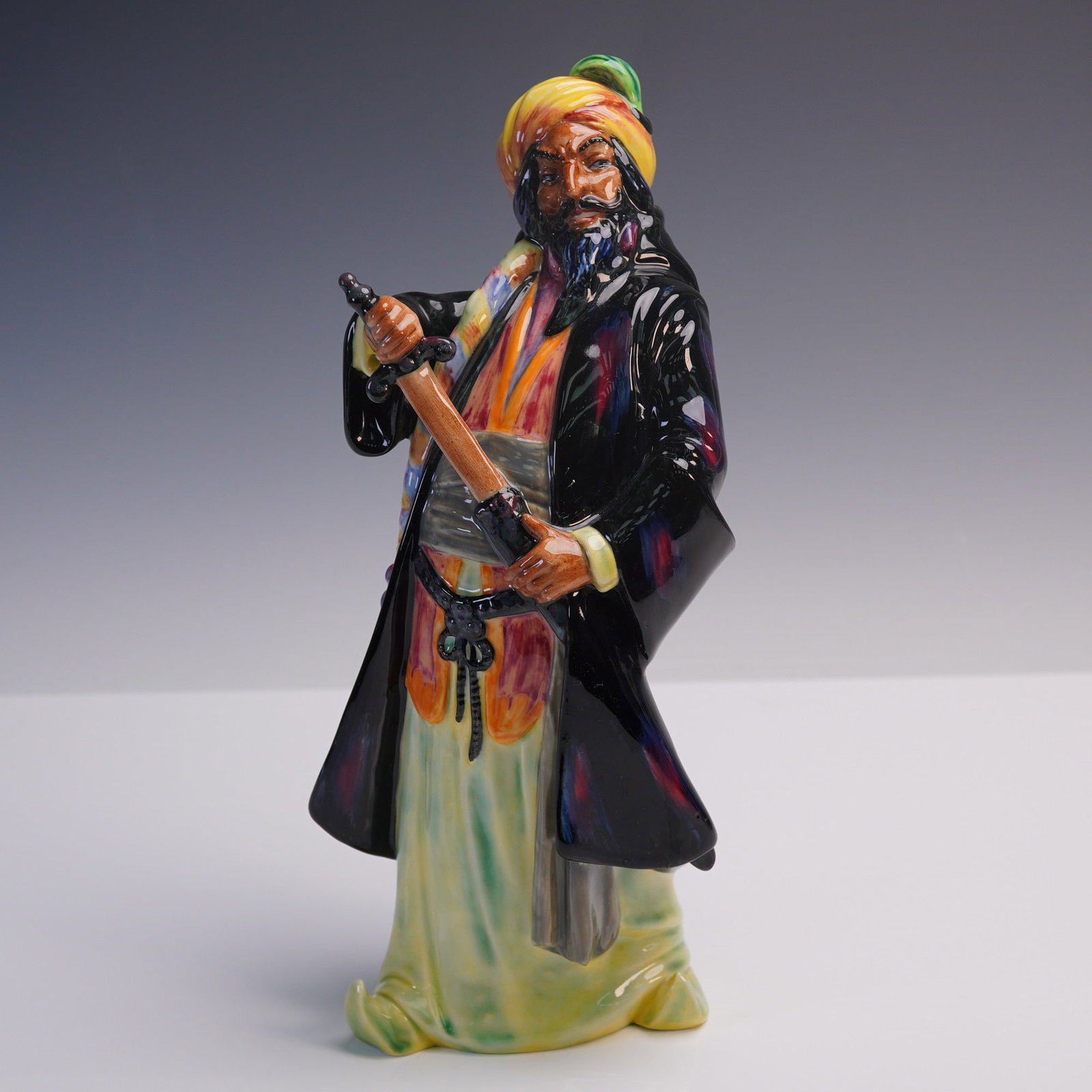 Royal Doulton Figurine, Blue Beard HN2105: A Royal Doulton figurine titled Blue Beard (HN2105), and issued in 1952 as part of the Characters from Literature series. Depicting the legendary figure with sword drawn and dressed in colorful robes 
