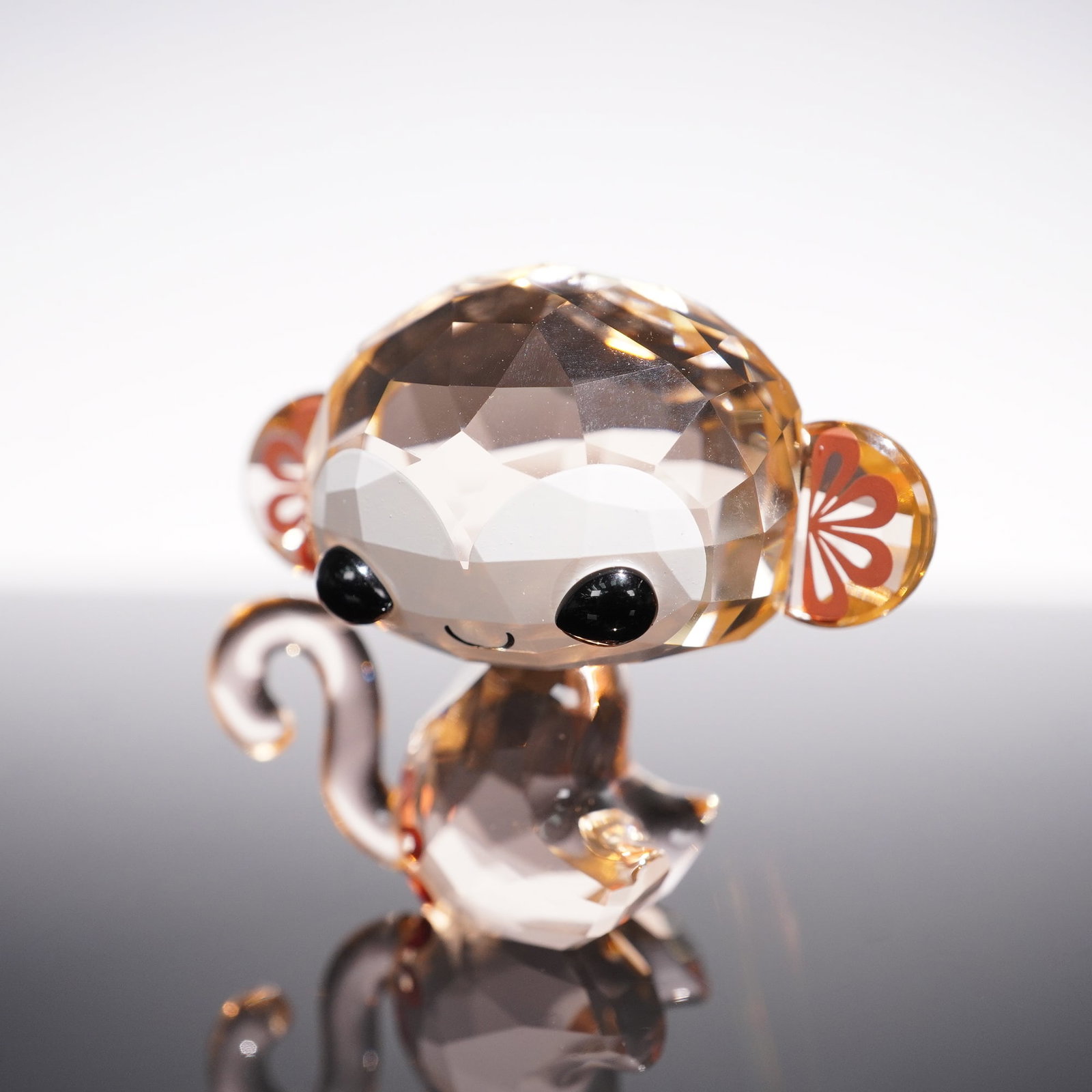 Swarovski Crystal Figurine, Lovlots Zodiac Kiki the Monkey: Full of charm, Kiki the monkey from Swarovski's Lovlots Zodiac series is crafted in faceted Light Peach crystal with Jet crystal eyes. Floral printed details on the ears add a playful accent to the de