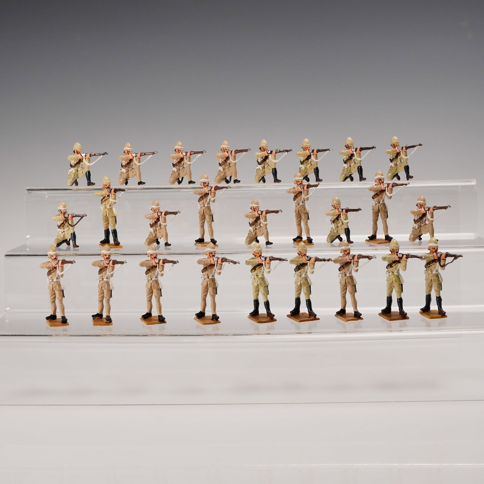 26pc El Templario Metal British Soldier Figurines: A 26 piece collection of hand-painted cast metal military figures depicting colonial era infantry in active engagement poses. Each figure is rendered in khaki uniform with white cross belts and pith h