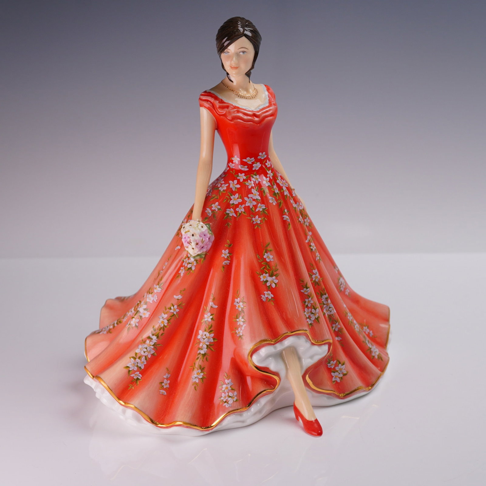 Royal Doulton Michael Doulton FOY 2017, Catherine May HN5826, Signed: A Royal Doulton bone china figurine titled Catherine May, HN5826, designed by Neil Faulkner as the Figure of the Year for 2017. This elegant figure features a young woman in a flowing red gown richly 