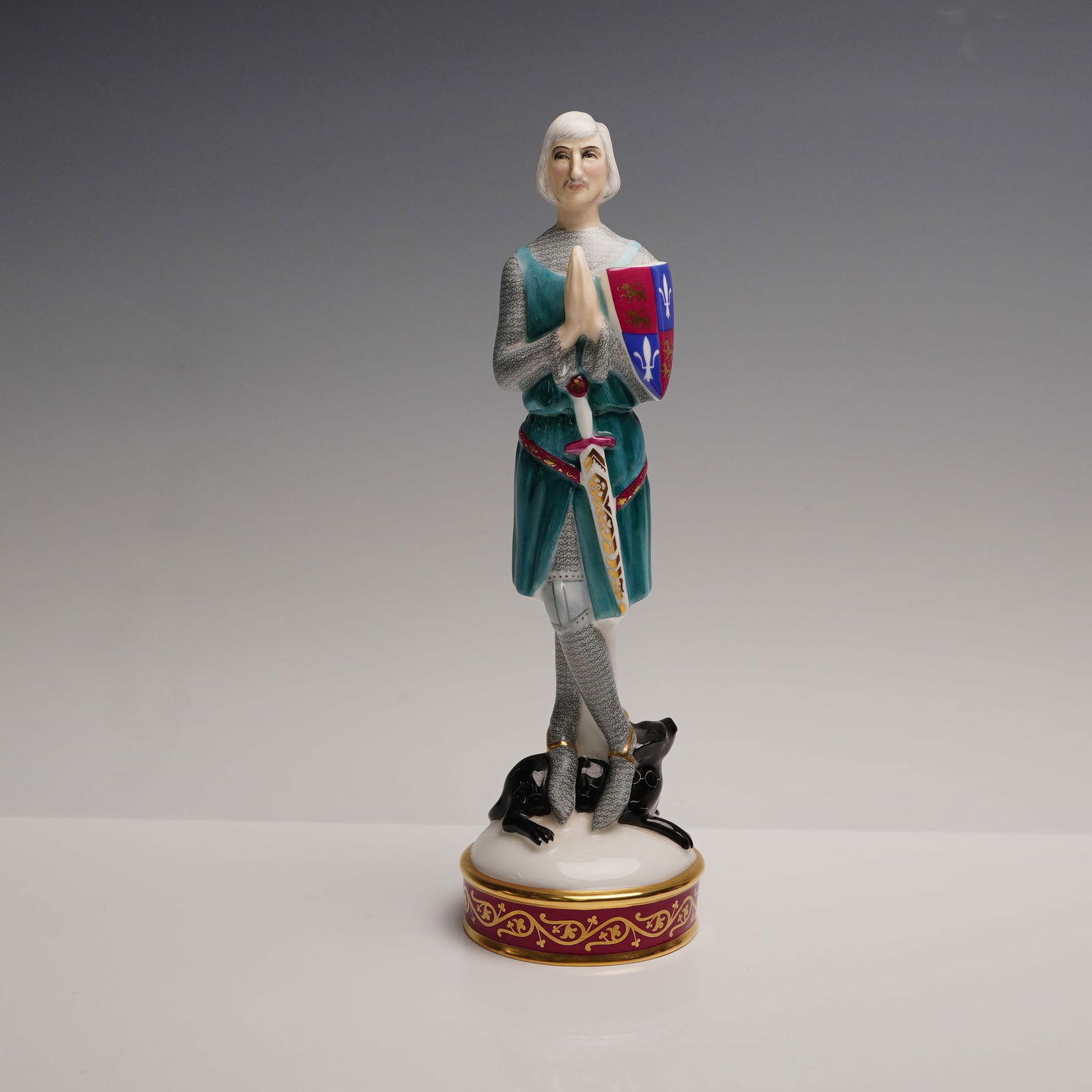 Royal Doulton Age of Chivalry Figurine, Sir Ralph HN2371, Signed: Part of the Age of Chivalry Collection. This hand-painted figure depicts a knight in full armor, shown standing in a solemn pose with hands clasped in prayer. He is dressed in a teal surcoat over chai