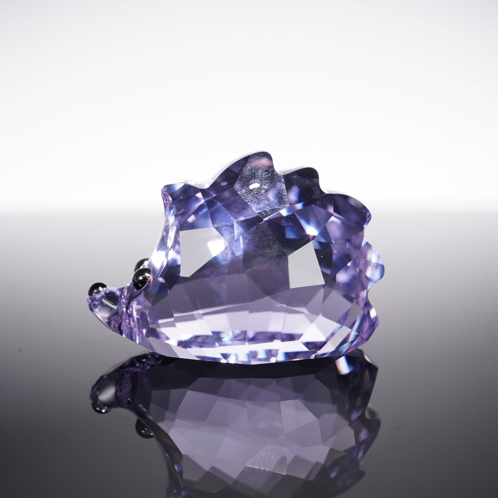 Swarovski Crystal Figurine, Lovlots City Park Spike the Hedgehog: Spike the hedgehog from Swarovski's Lovlots City Park series is crafted in faceted violet crystal with Jet Hematite crystal eyes and a Jet crystal nose. The vibrant design highlights Swarovski's playf
