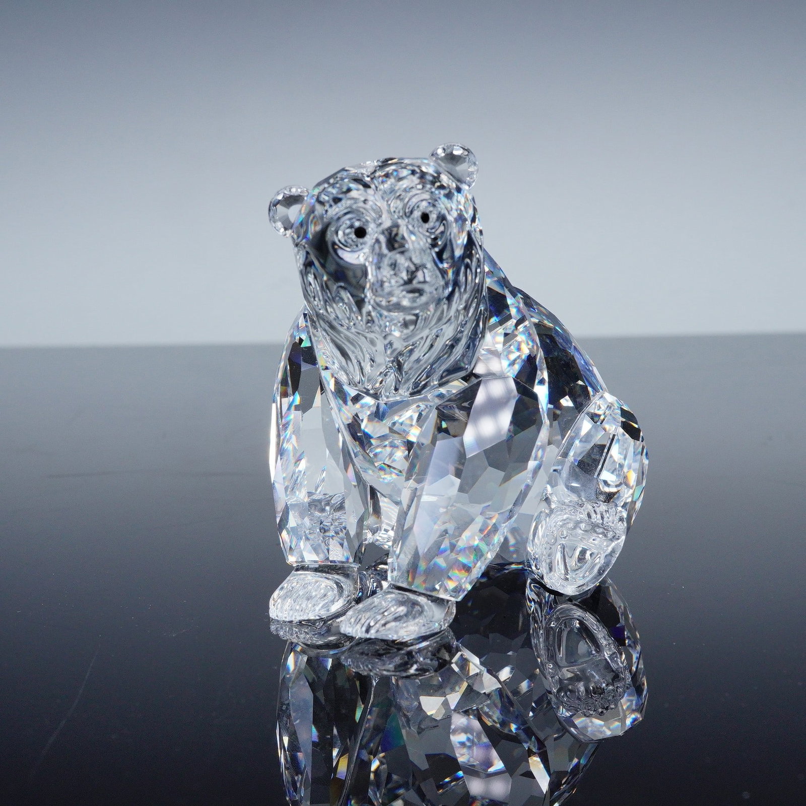 Swarovski Silver Crystal Figurine, Grizzly: This faceted, silver crystal figure is part of the Rare Encounters group. The grizzly has a clear faceted body and jet crystal eyes. Swarovski backstamp. This item has its original box. Artist: Heinz 