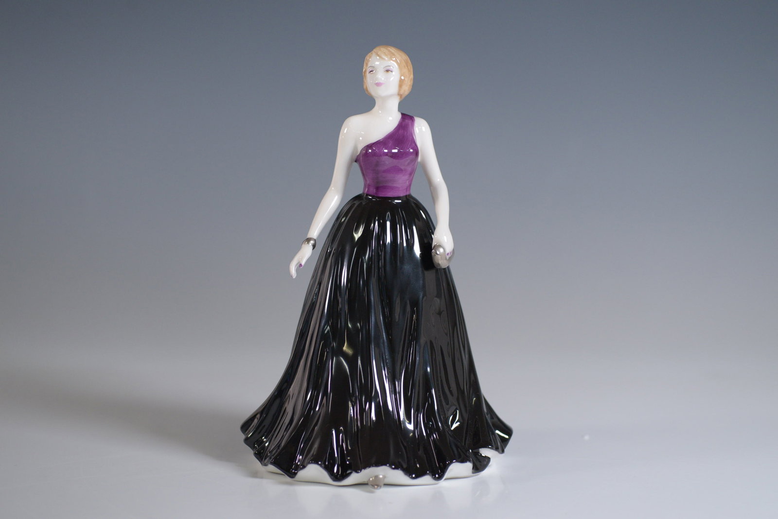 Royal Doulton Figurine, Caitlyn HN4666: Royal Doulton porcelain figurine titled Caitlyn, model number HN4666. This elegant figurine showcases a graceful young woman in a flowing gown, meticulously crafted with delicate detailing and fine ha