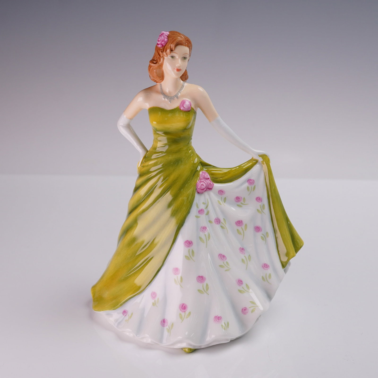 Royal Doulton Figurine Pretty Ladies Ella HN5441: Royal Doulton Pretty Ladies bone china figurine titled Ella from the Petite of the Year 2011 series. Designed by Neil Faulkner, this hand-decorated piece features a red-haired lady in a strapless gree